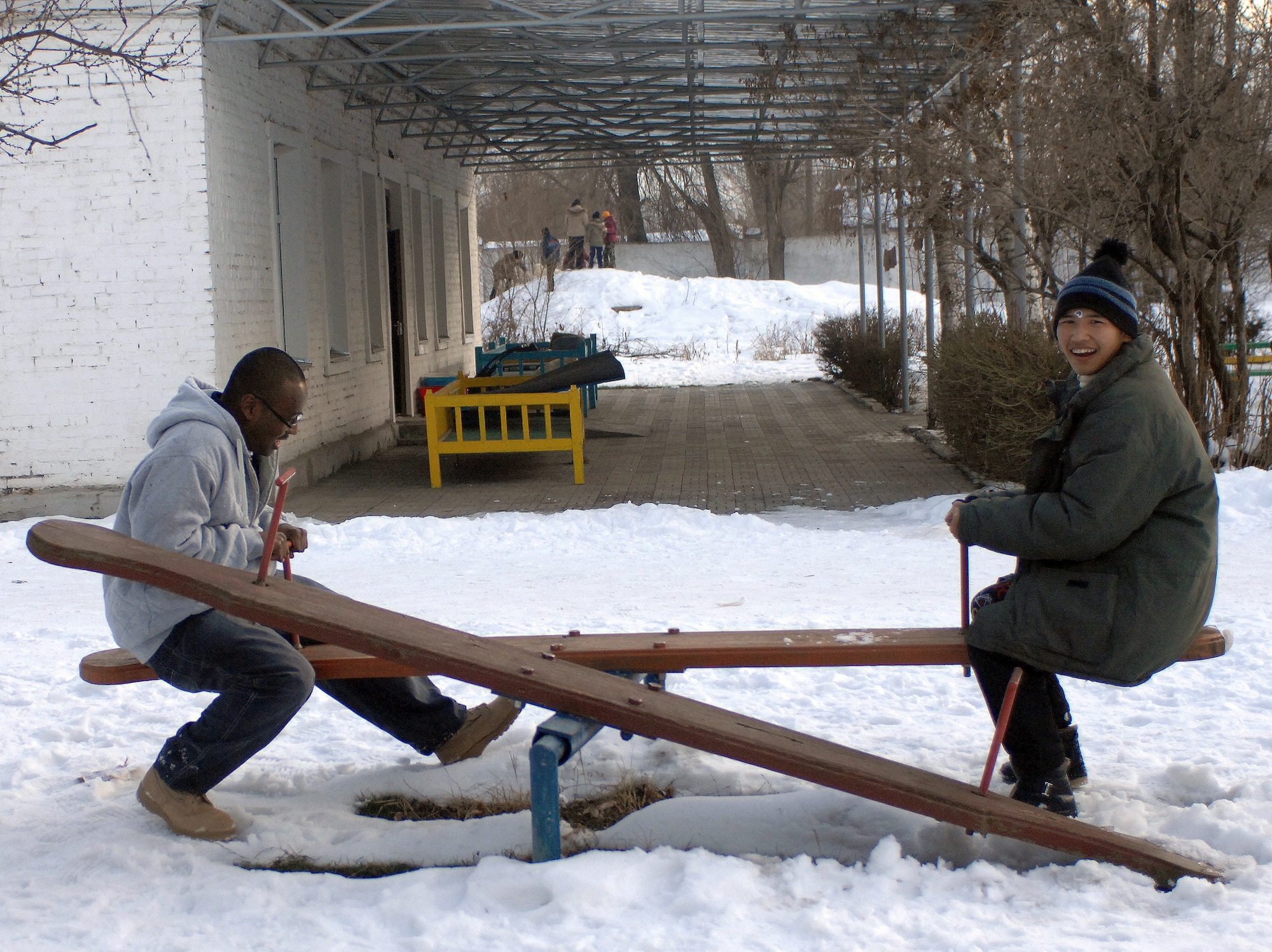 Airman Amir Mustafa plays on a teeter totter with a young boy Jan. 11 at the Belovodosky orphanage north of Bishkek, Kyrgyzstan. Airmen from nearby Manas Air Base visit the orphanage frequently to share friendship and donate toys as well as clothing, blankets, diapers and toiletries. Sergeant Mustafa is deployed with the 376th Expeditionary Logistics Readiness Squadron. (U.S. Air Force photo/Tech. Sgt. Phyllis Hanson) 

