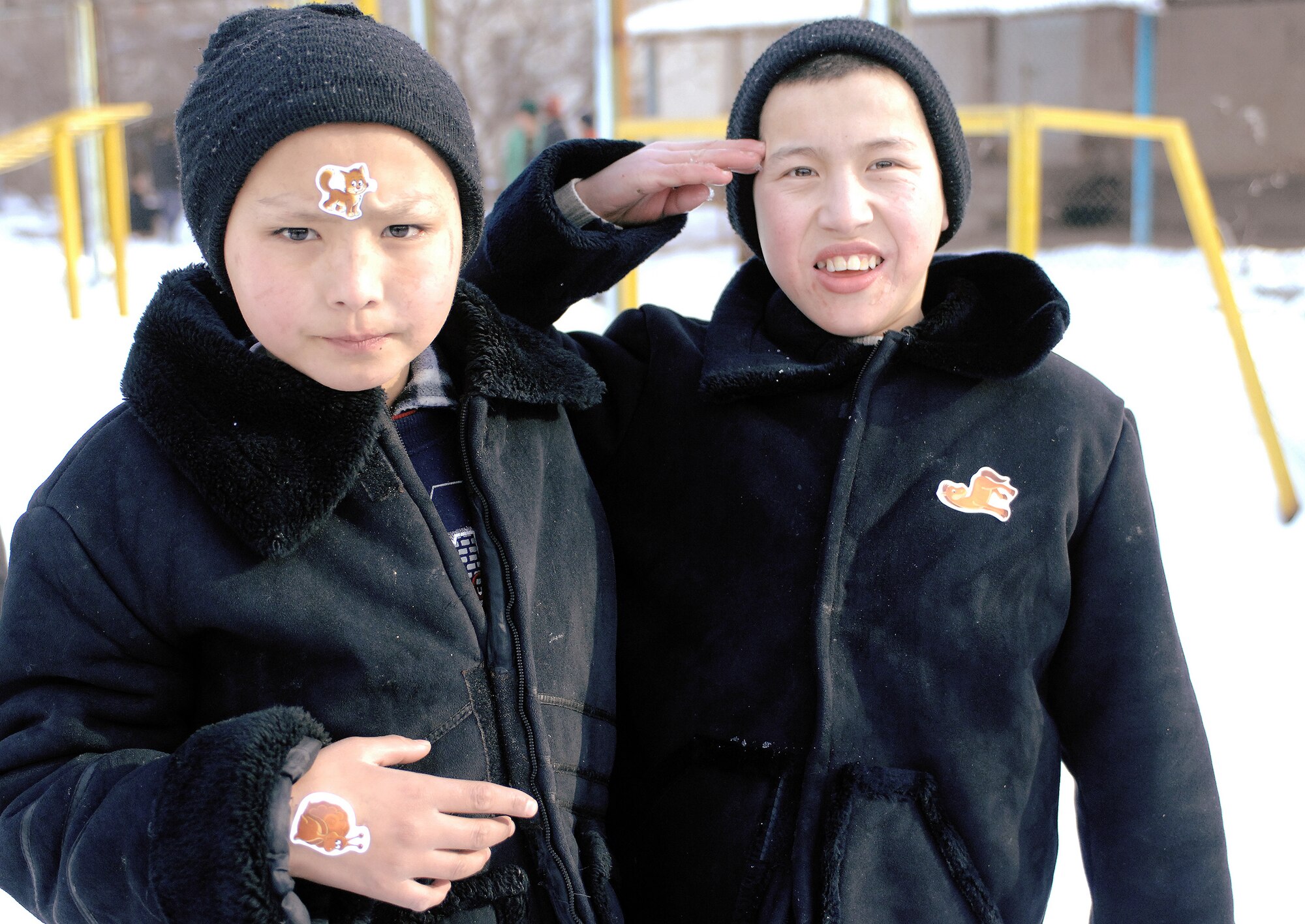 A young boy salutes in farewell with his friend Jan. 11 at the Belovodosky orphanage north of Bishkek, Kyrgyzstan. Airmen from nearby Manas Air Base visit the orphanage frequently to share friendship and donate toys as well as clothing, blankets, diapers and toiletries. (U.S. Air Force photo/Tech. Sgt. Phyllis Hanson) 
