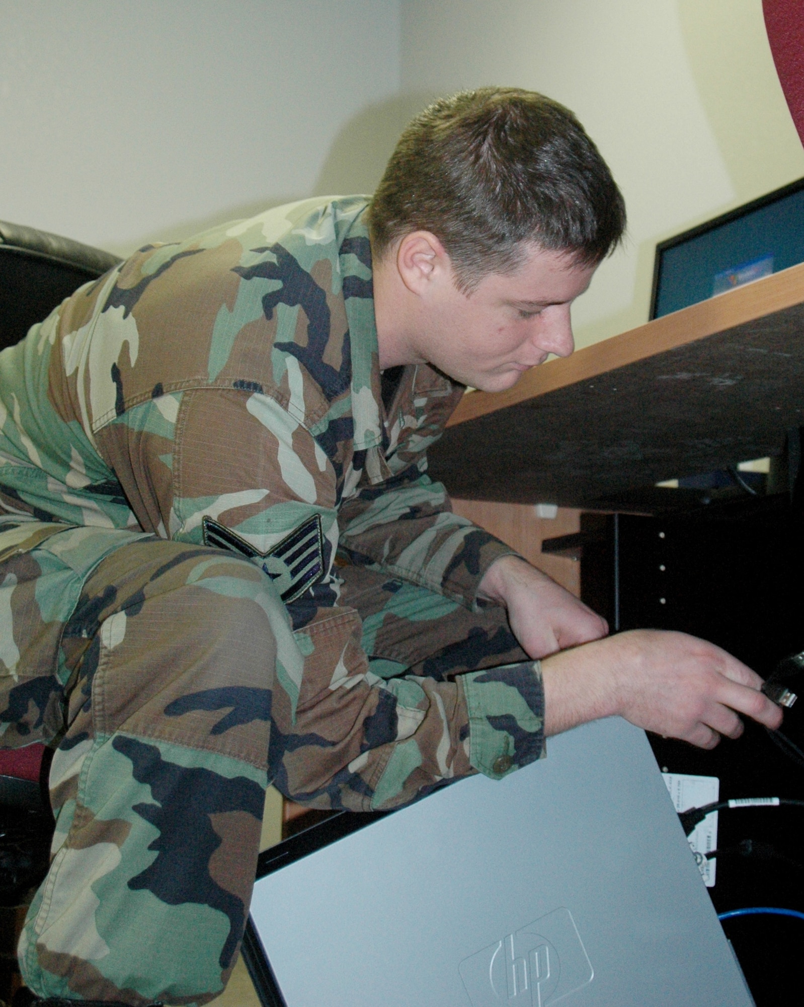 Staff Sgt. Joel Church, 33rd Operations Support Squadron aircrew flight equipment craftsman, sets up a computer for use at the Nomad University cyber cafe that will open Jan. 28.  The university is a 33rd Fighter Wing personnel-led venture to provide services for personnel who are relocating due to the wings drawdown. (U.S. Air Force Photo/Chrissy Cuttita)