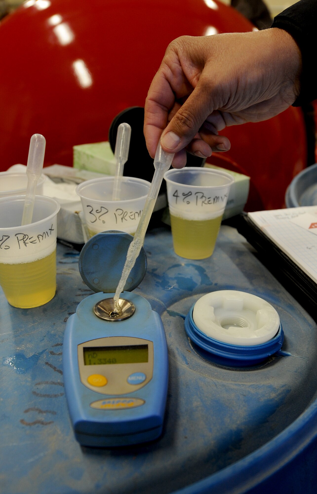 MOODY AIR FORCE BASE, Ga. – Edward Wolff, a contractor who tests the composition of the foam, tests samples of high expansion foam with a refractometer here Jan. 21. A refractometer tests the composition of the foam to ensure the correct mix of detergent and water is used. The results of the test will be compiled and sent to the Naval Safety Center to confirm its success. (U.S. Air Force photo by Senior Airman Gina Chiaverotti)