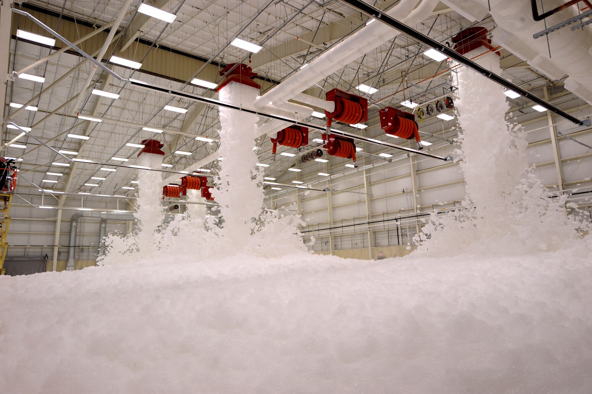 MOODY AIR FORCE BASE, Ga. – High expansion foam pours out of generators in a new A-10C Thunderbolt II fuels hangar here Jan. 21. The new system was tested for the first time before the scheduled opening of the building Feb. 14. The results will be sent to the Naval Safety Center to ensure the test was successful. (U.S. Air Force photo by Senior Airman Gina Chiaverotti)