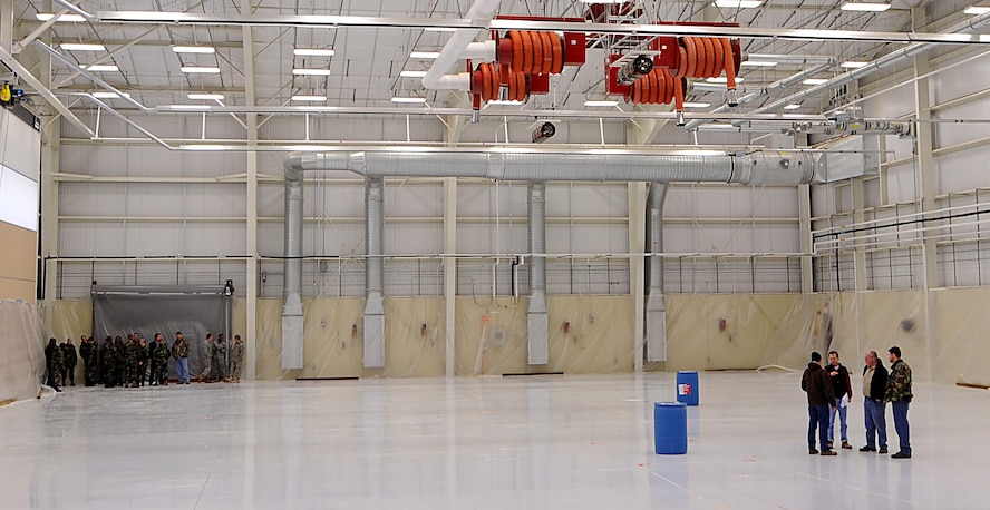 MOODY AIR FORCE BASE, Ga. -- Contractors working in support of the fire suppression foam system installed in the new A-10C Thunderbolt II fuels hangar discuss details about a fire suppression foam test while members of the base fire department stand by here Jan. 21. The high expansion foam test is one of the final phases in the building construction. In order to be certified the test must produce three feet of foam in four minutes. (U.S. Air Force photo by Senior Airman Gina Chiaverotti)