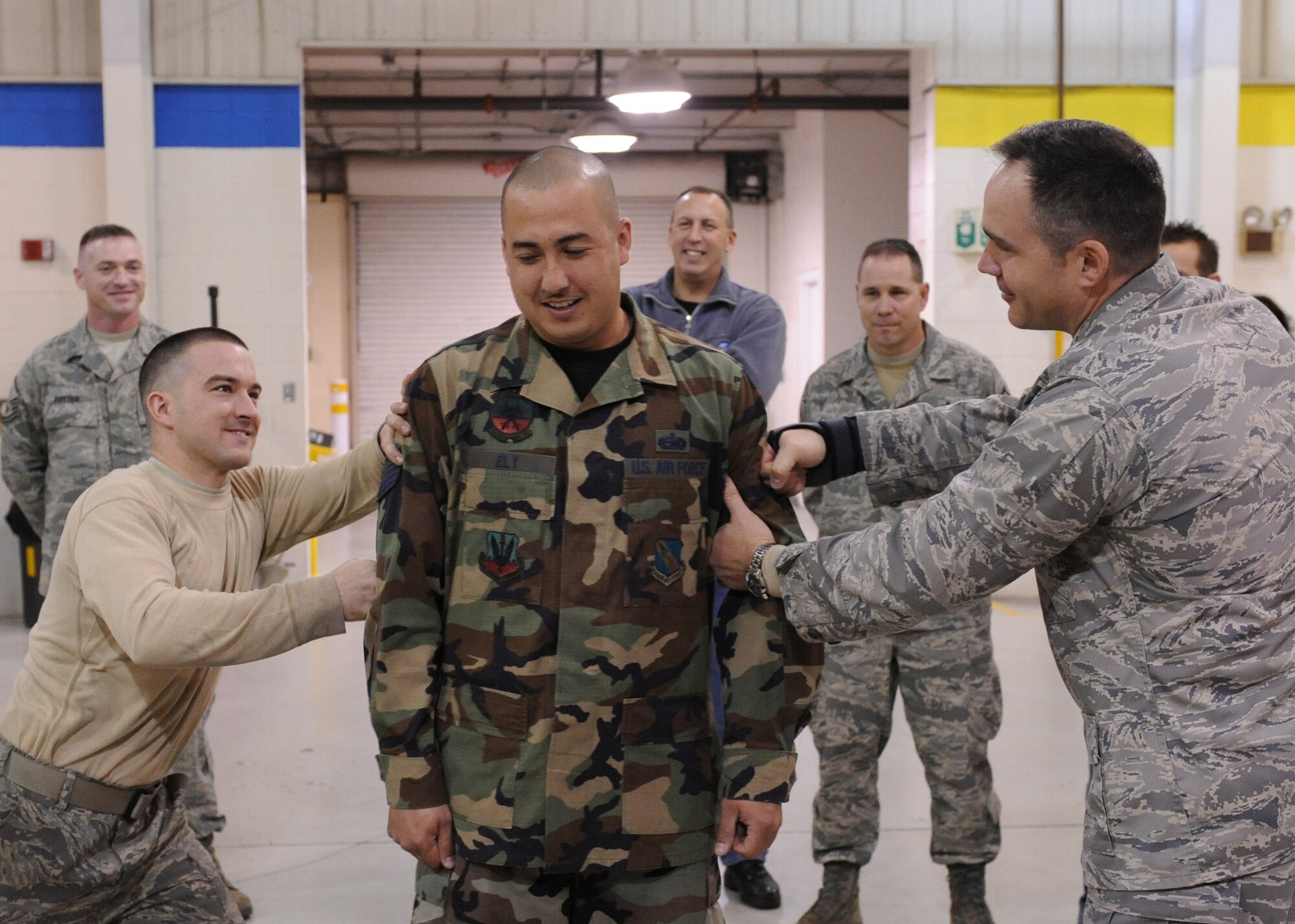 Members of the 4th Equipment Maintenance Squadron look on as Tech Sgt. Todd Ely has his new stripes pinned on after a surprise promotion Dec. 24, 2008 here at Seymour Johnson Air Force Base, N.C. The Stripes for Extraordinary Performers programs rewards outstanding Airmen with promotions outside of their promotion cycle. (U.S. Air Force photo by Airman 1st Class Whitney Stanfield)

