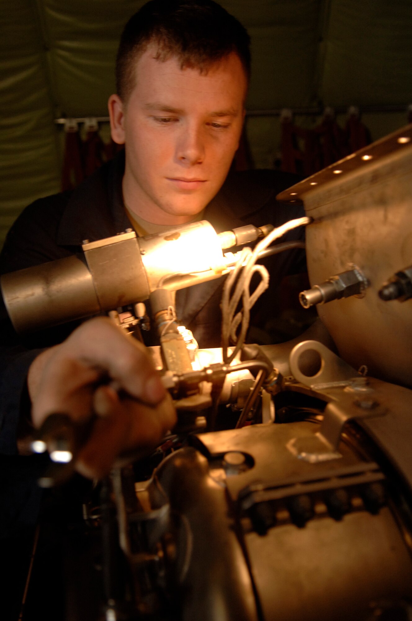 Senior Airman Nick Dresser works on an auxillary power unit of a KC 135 from the 459th Air Refueling Wing here Jan. 15. The auxillary power unit gives air and starts the main engines of a KC 135. The KC 135 from the 459th ARW is here for a periodic inspection due to manning issues. The plane arrived at MacDill Jan. 8 and is in its final stages of inspection. It is the third plane from Andrews to be inspected by the men and women of the 6th Maintenance Group.