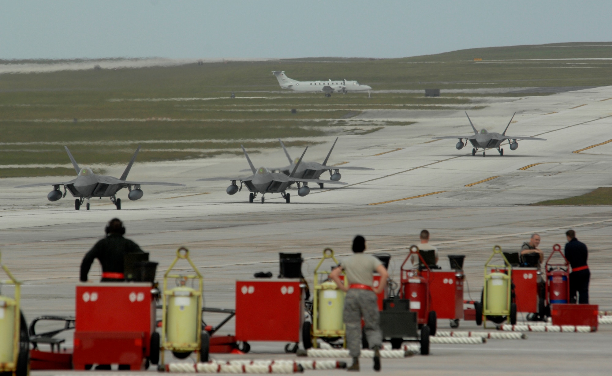 Maintainers prepare for the arrival of F-22 Raptors Jan. 18 deployed from Elmendorf Air Force Base, Alaska, at Andersen AFB, Guam. Andersen AFB officials received 12 F-22s and more than 250 Airmen for a three-month deployment. (U.S. Air Force photo/Master Sgt. Kevin J. Gruenwald) 