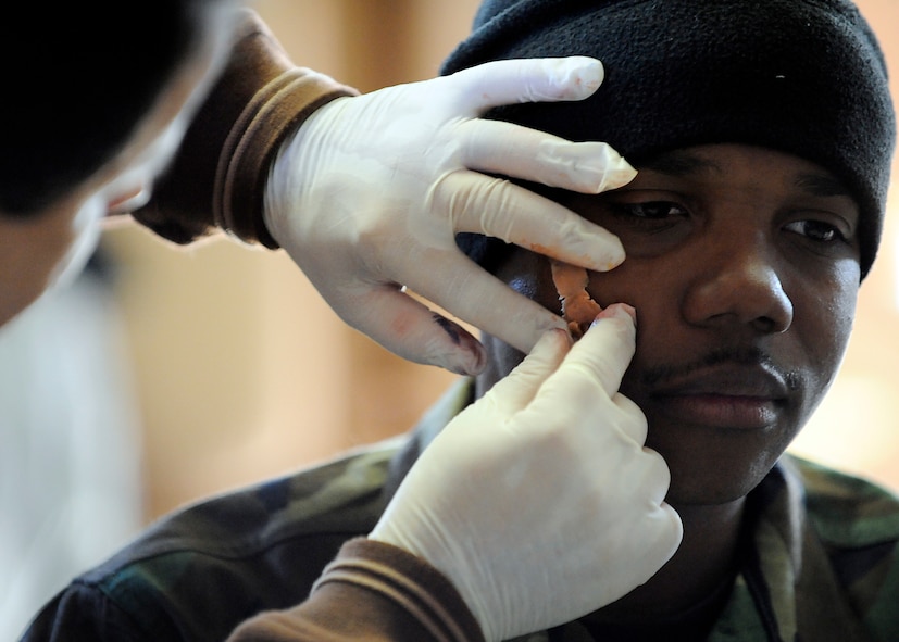 MOODY AIR FORCE BASE Ga., - -  Airman 1st Class Arthur William, 822nd Security Forces Squadron, is made up to look like a victim for an All-Hazards Response Training exercise here Jan. 22. Approximately 12 members from the 822nd SFS were given fake lacerations, burns and blisters to simulate wounds received during an explosion and blister agent attack. (U.S. Air Force photo by Senior Airman Brittany Barker)