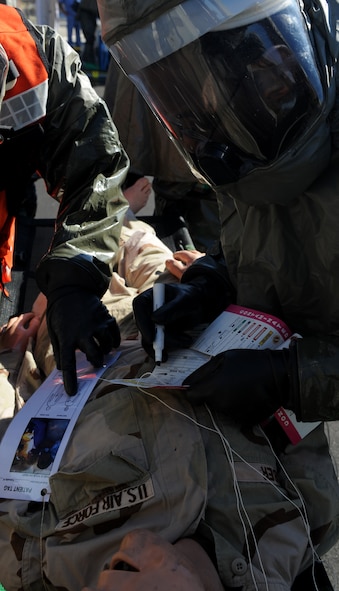 MOODY AIR FORCE BASE, Ga. -- A member of the 23rd Medical Group reads the patient tag of a simulated victim during an All-Hazards Response Training exercise here Jan. 22. The purpose of the exercise was to test the 23rd Medical Group personnel on their ability to quickly asses and stabilize injured patients during the exercise scenarios. (U.S. Air Force photo by Senior Airman Gina Chiaverotti)