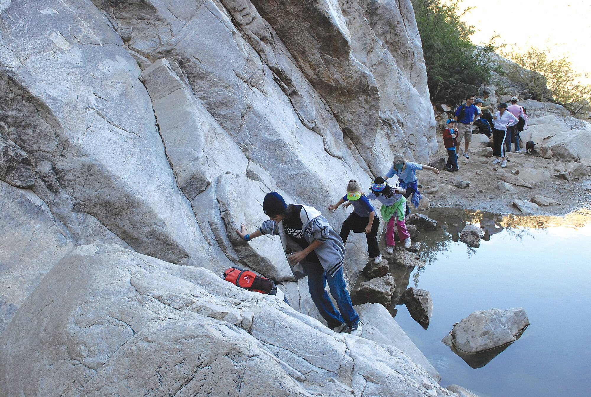 Members of the 56th Services Squadron Youth Center climb the last leg of Waterfall Trail in the White Tank Mountain Regional Park Saturday. The youth center plans activities for children of all ages and includes 2-on-2 basketball, game room tournaments and photography class. For more information and schedule of events, call (623) 856-6225. (U.S. photo/ Airman 1st Class C.J. Hatch.)