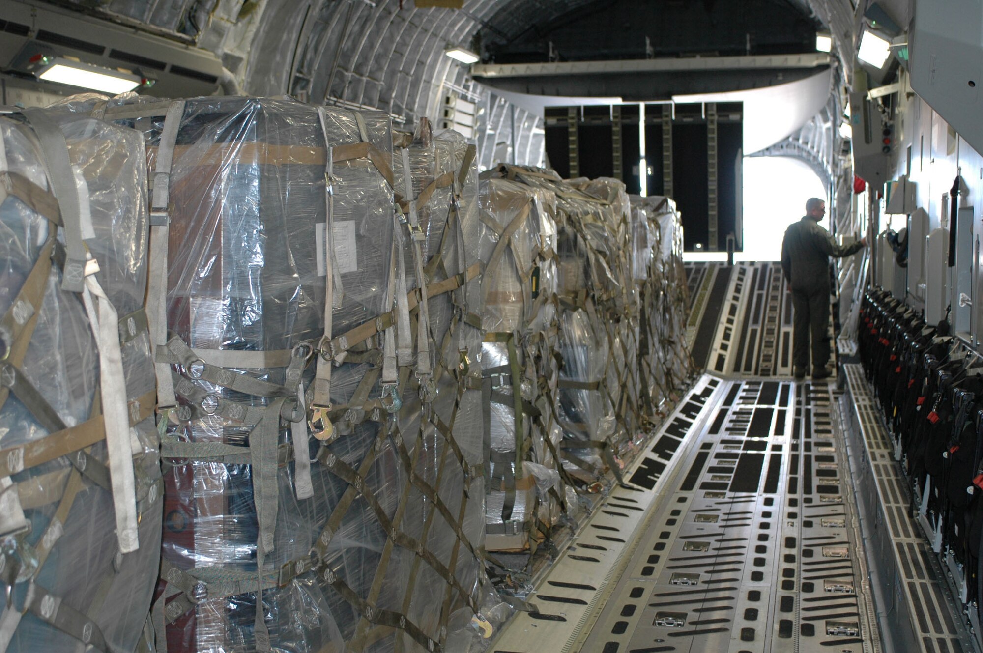 DOVER AIR FORCE BASE, Del. -- Master Sgt. Mike Wright, a loadmaster with the Air Force Reserve's 326th Airlift Squadron, prepares a C-17 Globemaster to unload humanitarian cargo at the Managua International Airport, Nicarauga, Jan. 18. Approximately 18,000 pounds of cargo consisting of desks, chairs, file cabinets and books were delivered for use at a Nicaraugan university library as part of the Denton Program. The Denton Program is a Department of Defense transportation program that uses available military air, surface and sea-lift assets to deliver humanitarian cargo donated by charities or private donors. (U.S. Air Force photo/Capt. Marnee A.C. Losurdo)