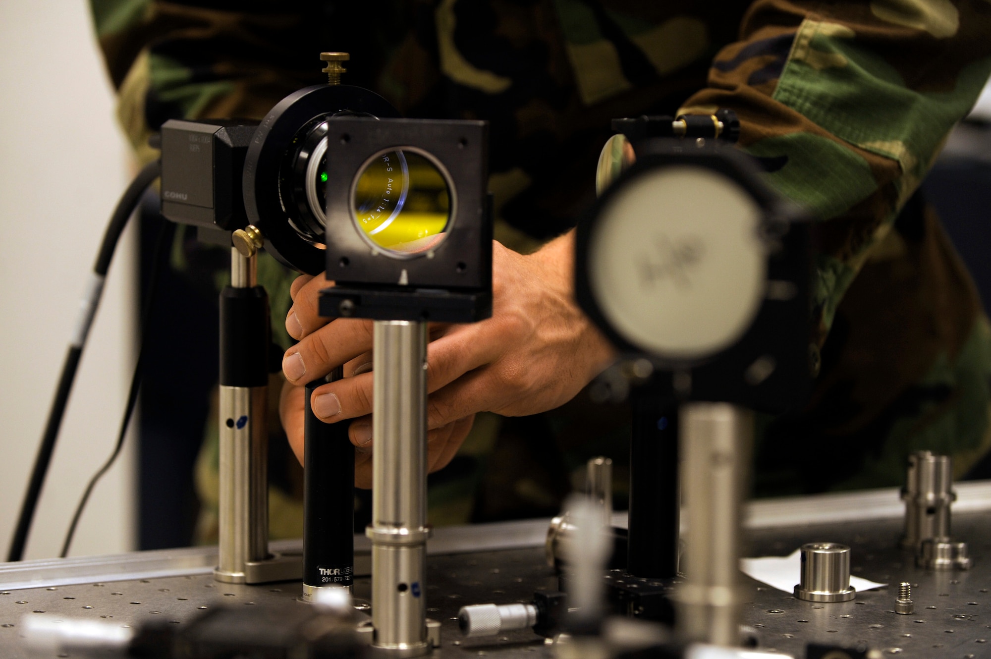 U.S. Air Force Academy Cadet Will Holmes adjusts an optical mount as he conducts holographic adaptics optics research Jan. 22 at the Academy in Colorado. Cadet Holmes is a senior at the Academy. (U.S. Air Force photo/Staff Sgt. Desiree N. Palacios) 
