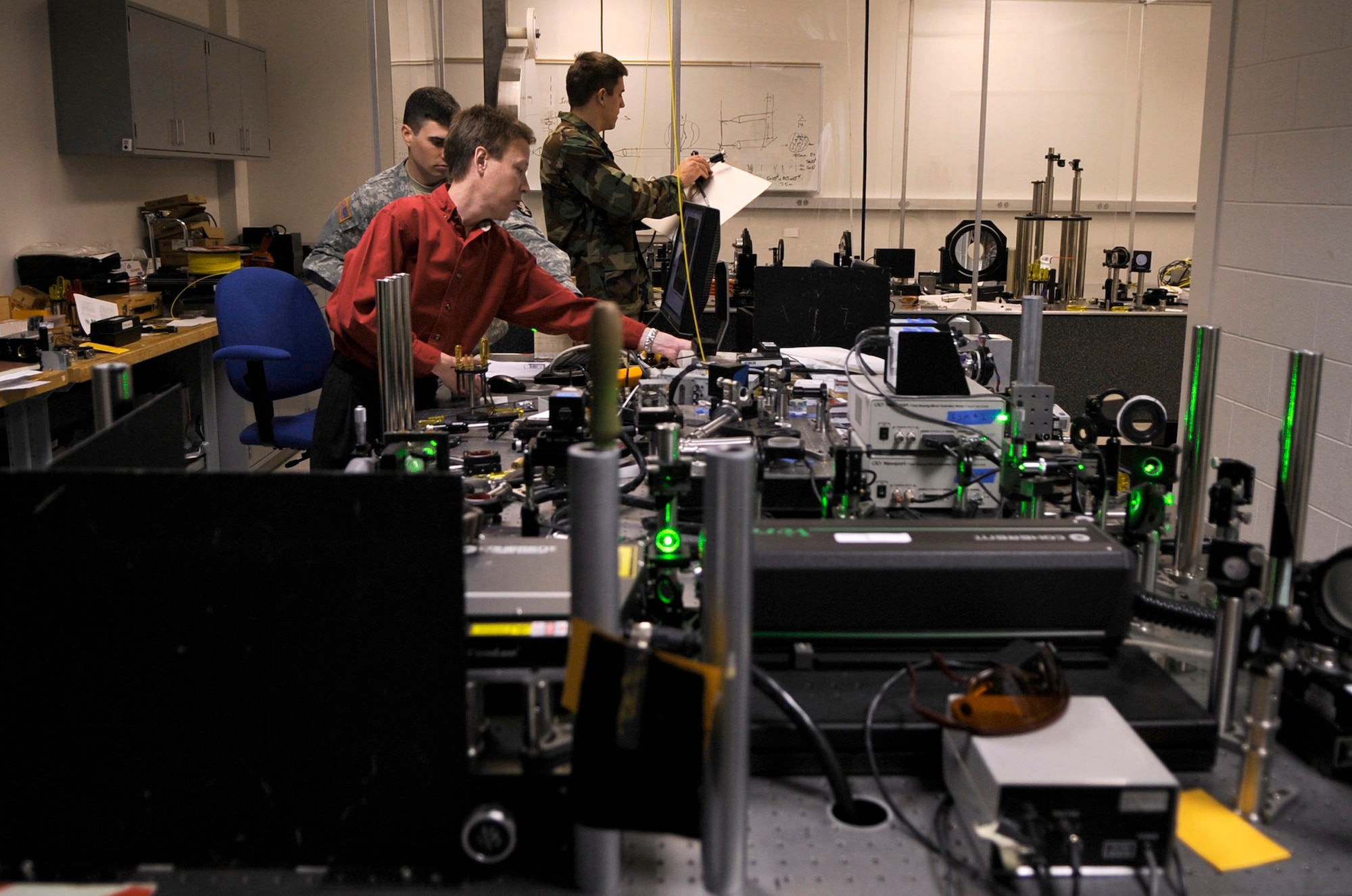 Dr. Geoff Andersen conducts holographic adaptics optics research with U.S. Military Academy Cadet Richard Carter and U.S. Air Force Academy Cadet Will Holmes Jan. 22 at the Academy in Colorado. Dr. Andersen is a research associate, teaches cadets and conducts experiments at the Laser and Optics Research Center. Cadet Carter is a junior in a exchange unit from West Point and Cadet Holmes is a senior at the Academy. (U.S. Air Force photo/Staff Sgt. Desiree N. Palacios) 

