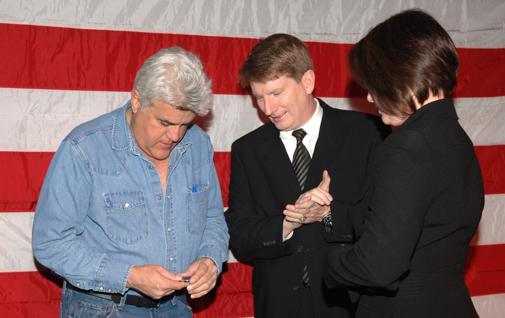 AIRWAY HEIGHTS, Wash. – Comedian Jay Leno examines the 92nd Air Refueling Wing commander’s coin after receiving it from Col. Robert Thomas, 92nd ARW commander, Jan. 17 at the Northern Quest Casino in Airway Heights, Wash. Mr. Leno took an hour out of his busy schedule to meet with military members, sign autographs and pose for photos before his performance. (U.S. Air Force photo / Senior Airman Jocelyn A. Ford)
