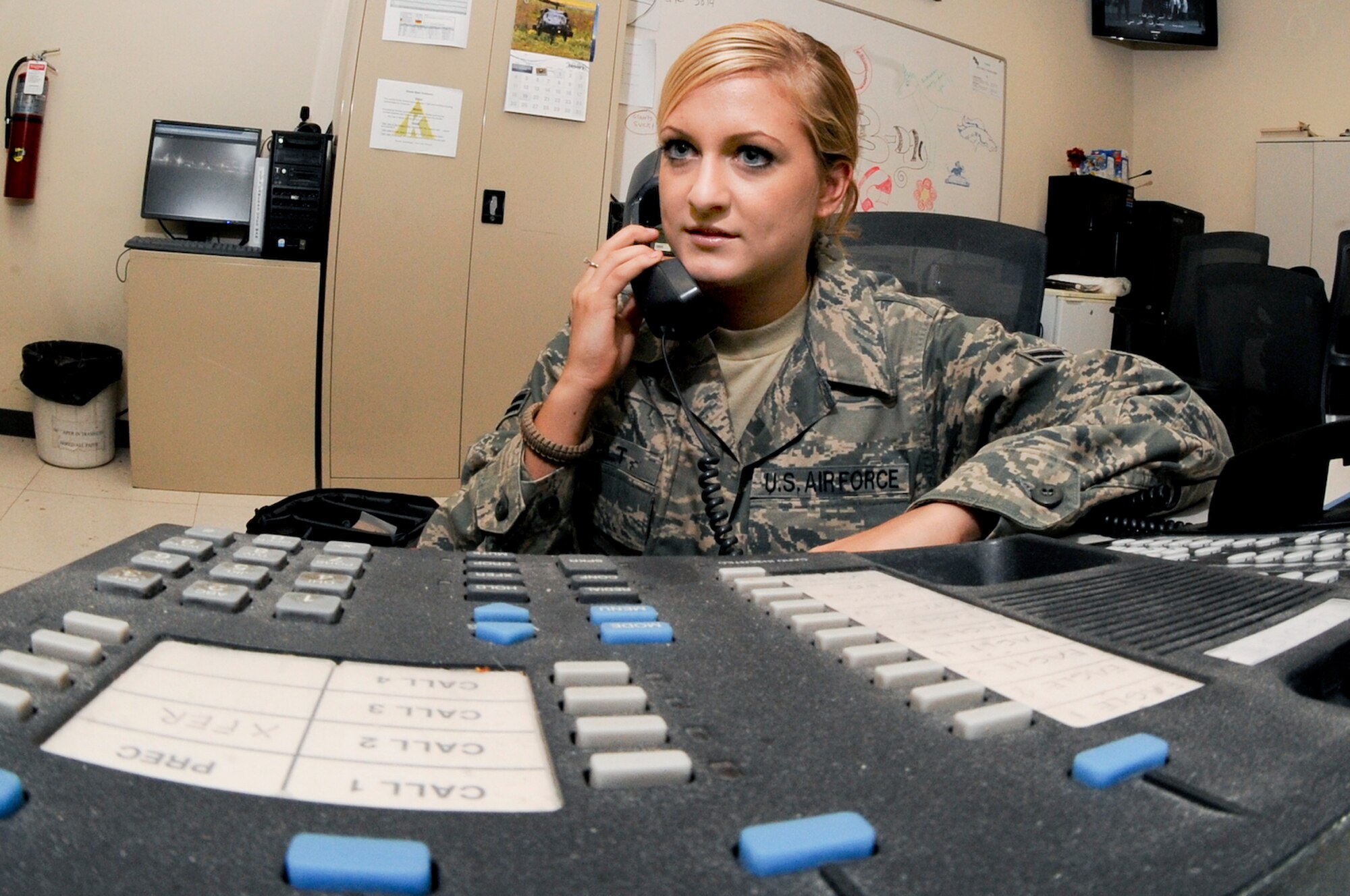 Airman 1st Class Jennifer Holt, the Flight Following Controller for the 379th Air Expeditionary Wing, receives a phone call over the Secure Telephone Equipment unit, Jan. 21, 2009, in an undisclosed location in Southwest Asia. The STE allows the user to send and receive encrypted secure calls.  Airman Holt is originally from LaGrange Ill. and is deployed from Luke Air Force Base, Ariz., in support of Operations Iraqi and Enduring Freedom and Joint Task Force-Horn of Africa.  (U.S. Air Force Photo by Staff Sgt. Joshua Garcia/Released)