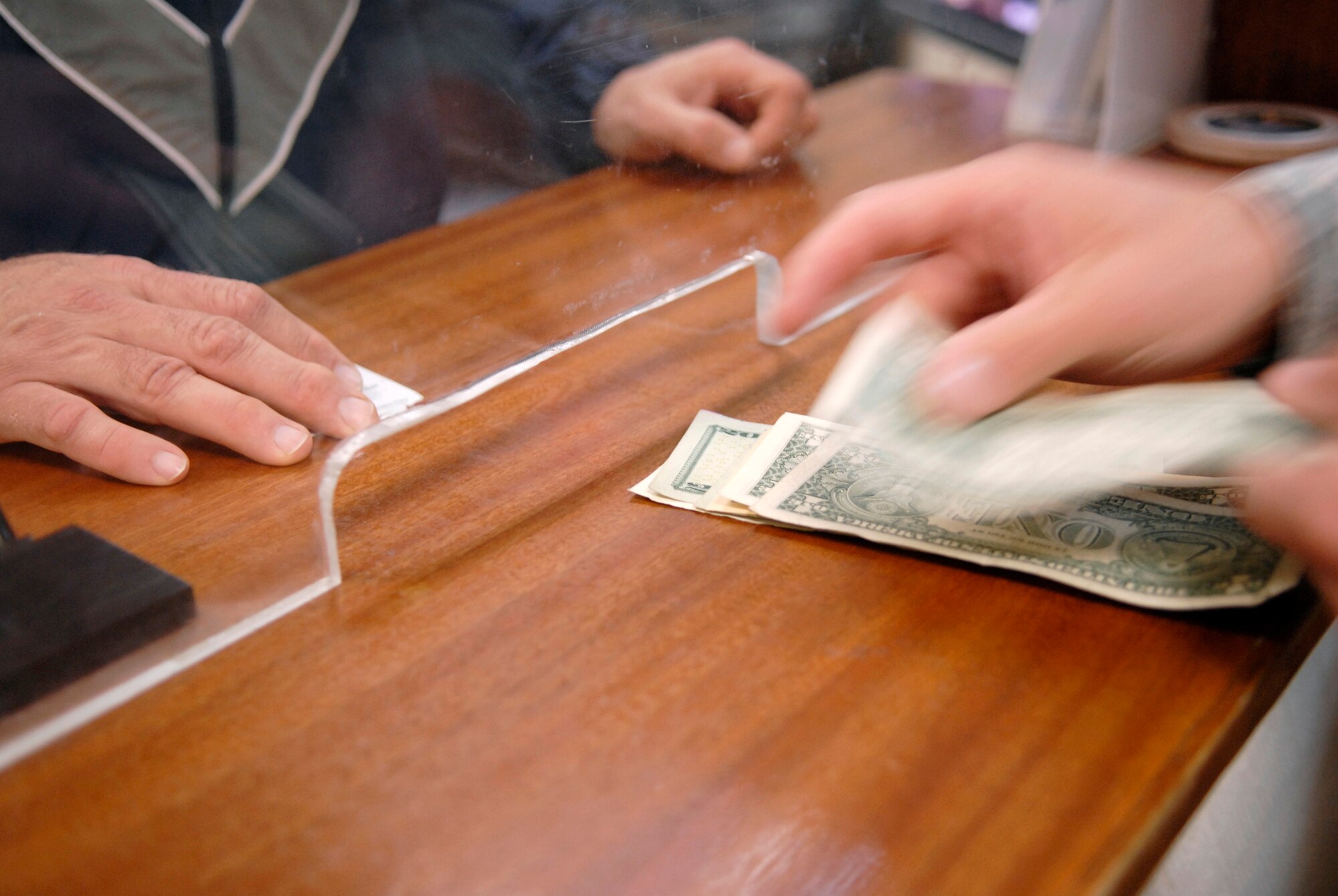 Staff Sergeant Justin Hughes, a 379th Expeditionary Comptrollers Squadron Cashier, counts out cash for a withdrawl for an Airman on base Jan. 22 at an undisclosed location in Southwest Asia.  Staff Sgt. Hughes assists Airmen with currency exchanges, cashing checks, and making cash withdrawls.  Staff Sgt. Hughes hails from Anaconda, Mont. and is deployed from Mountain Home Air Force Base, Idaho in support of Operation Iraqi and Enduring Freedom and Joint Task Force- Horn of Africa.  (U.S. Air Force Photo by Airman 1st Class Andrew Satran/Released)