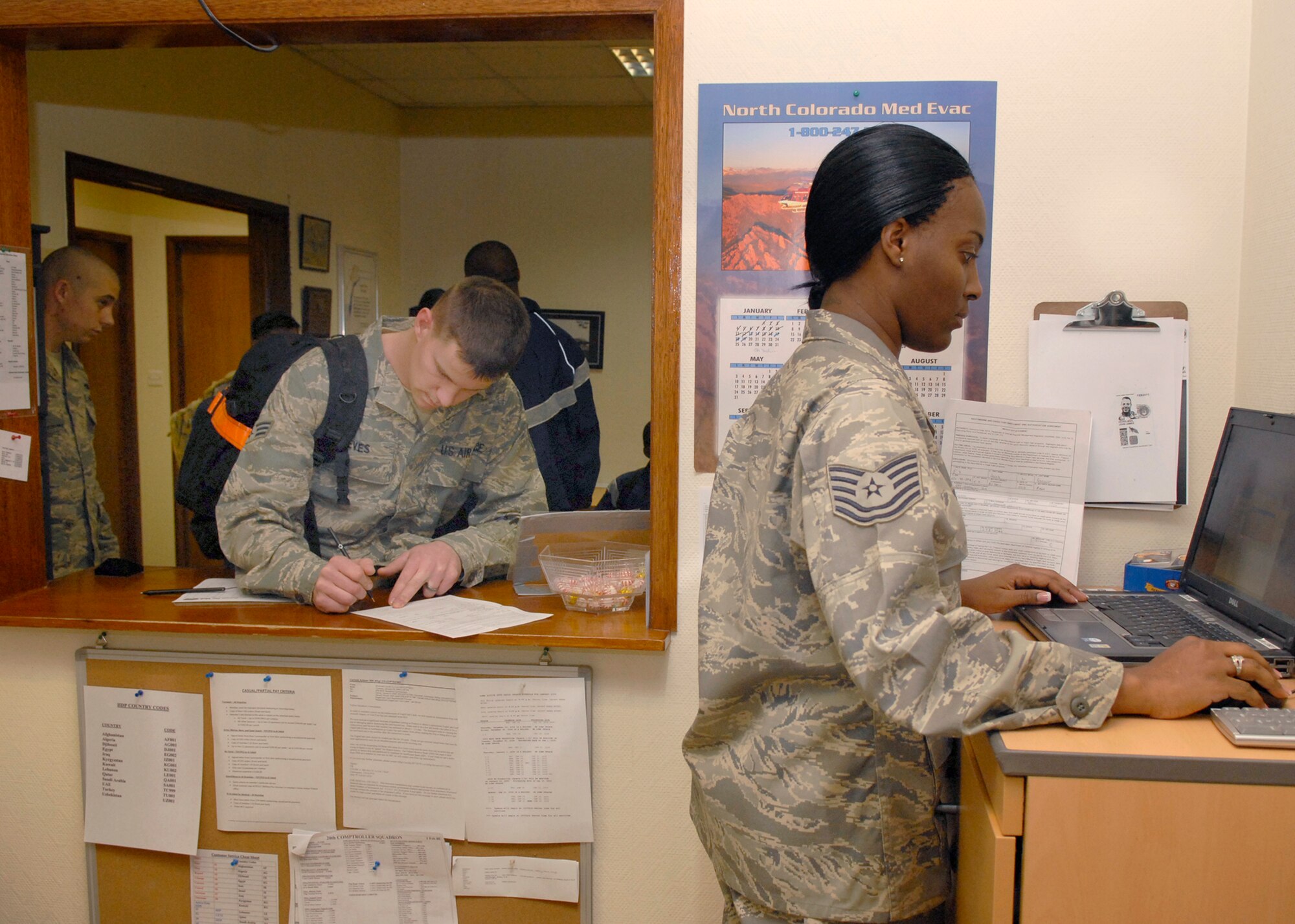 Technical Sergeant Shurenthel Taylor, a 379th Expeditionary Comptrollers Squadron Customer Service NCOIC, assists Airmen with Eagle Cash debit cards, Jan. 22, 2009, at an undisclosed location in Southwest Asia.  Finance personnel assist Airmen with savings deposits, military pay accounts, and Eagle Cash cards.  Tech. Sgt. Taylor hails from Pearl, Miss. and is deployed from Thompson Field Air National Guard Base, Miss. in support of Operation Iraqi and Enduring Freedom and Joint Task Force- Horn of Africa.  (U.S. Air Force Photo by Airman 1st Class Andrew Satran/Released)
