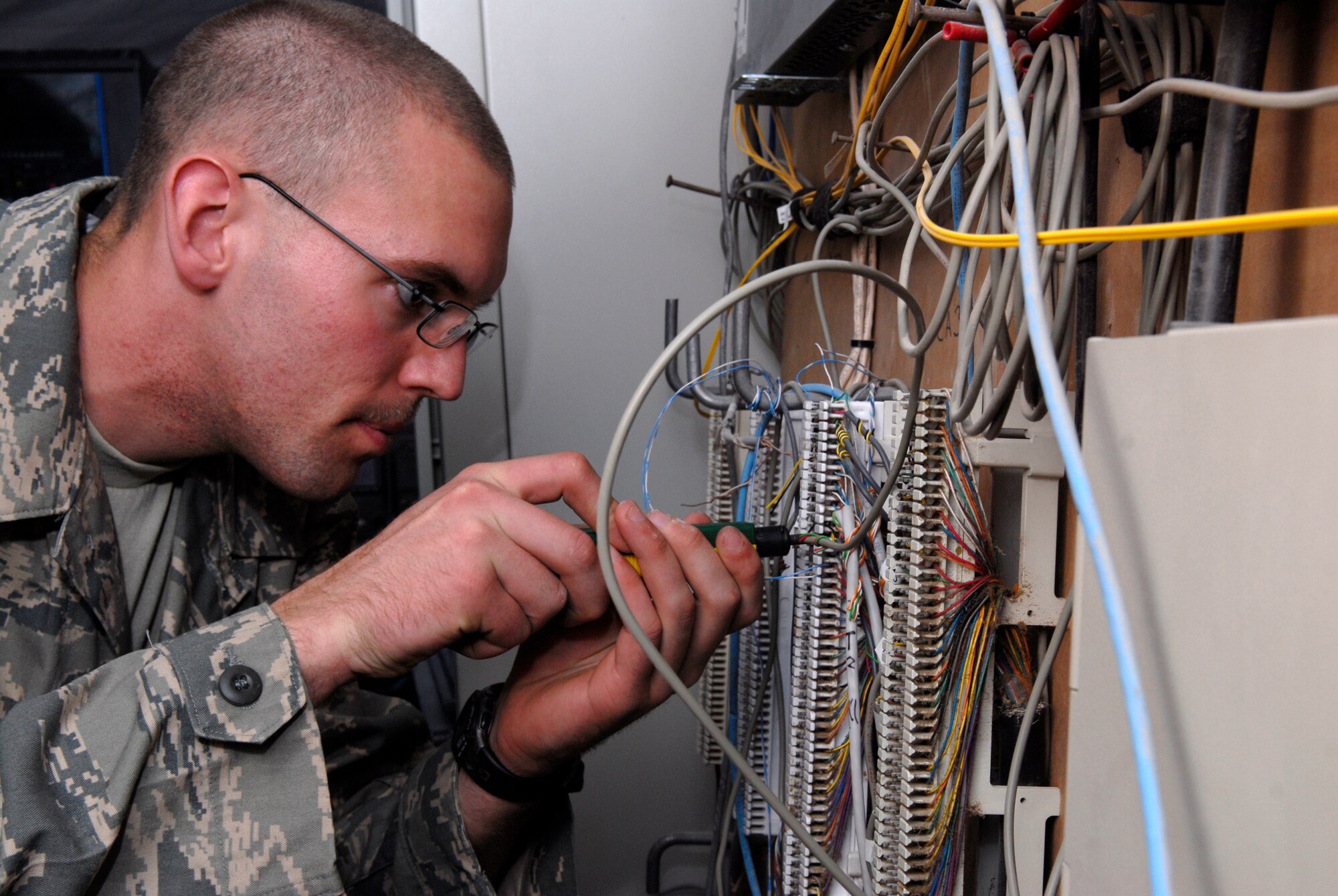 Airman 1st Class Lee Welty, a 71st Expeditionary Air Control Squadron Theatre Deployed Communications Apprentice, re-wires telephone lines, Jan. 22, 2009 in an undisclosed location in Southwest Asia.  Airman Welty hails from Findley, Ohio and is deployed from Aviano Air Base, Italy in support of Operation Iraqi and Enduring Freedom and Joint Task Force- Horn of Africa.  (U.S. Air Force Photo by Airman 1st Class Andrew Satran/Released)

