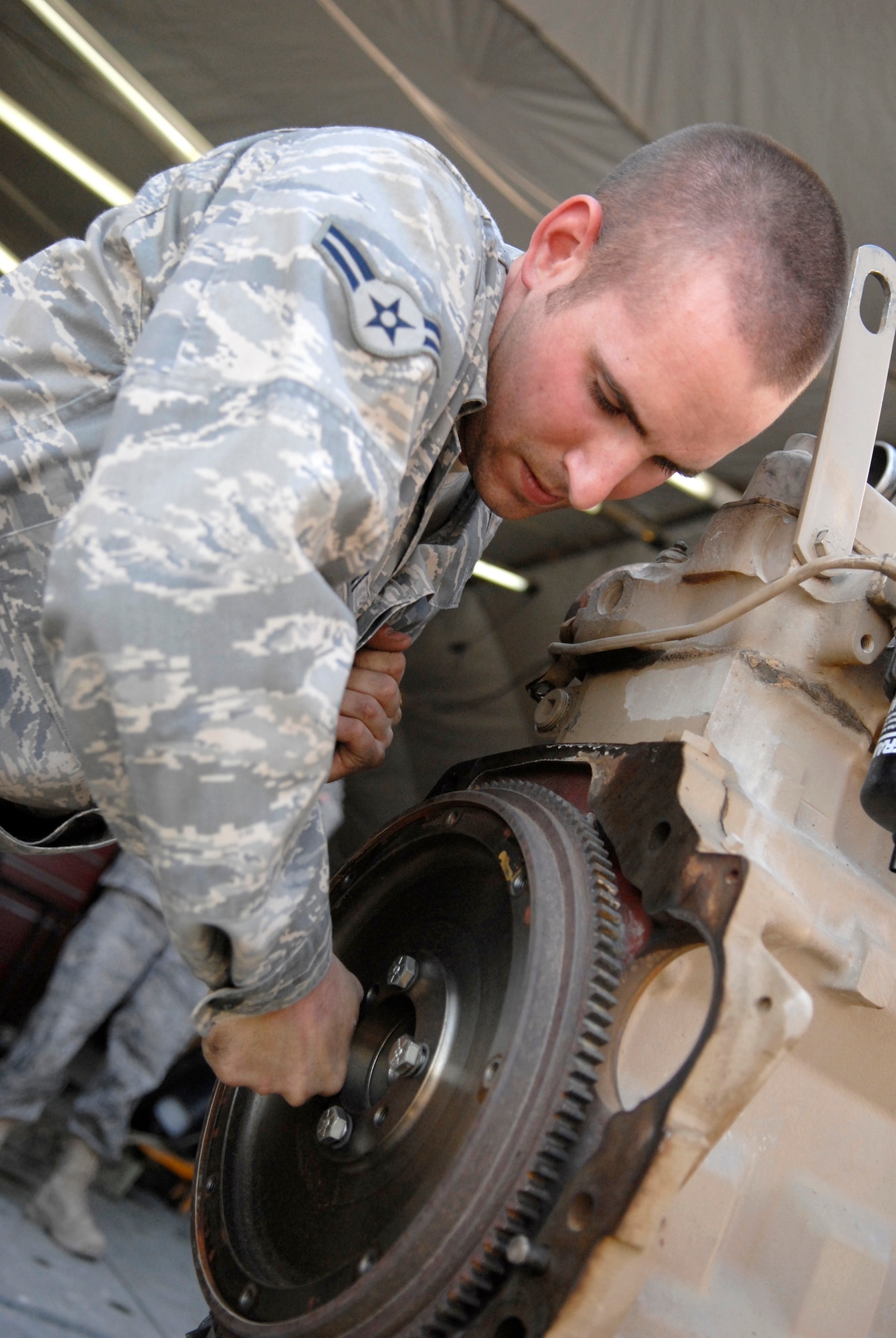 Airman 1st Class Mark Barnett, a 71st Expeditionary Air Control Squadron Electronic Power Production Apprentice, performs maintenance on a 400 hertz, 60 kilowatt engine for an operations generator module, Jan. 22, 2009, at an undisclosed location in Southwest Asia.  Airman Barnett hails from Dublin, Calif. and is deployed from Aviano Air Base, Italy in support of Operation Iraqi and Enduring Freedom and Joint Task Force- Horn of Africa.  (U.S. Air Force Photo by Airman 1st Class Andrew Satran/Released)