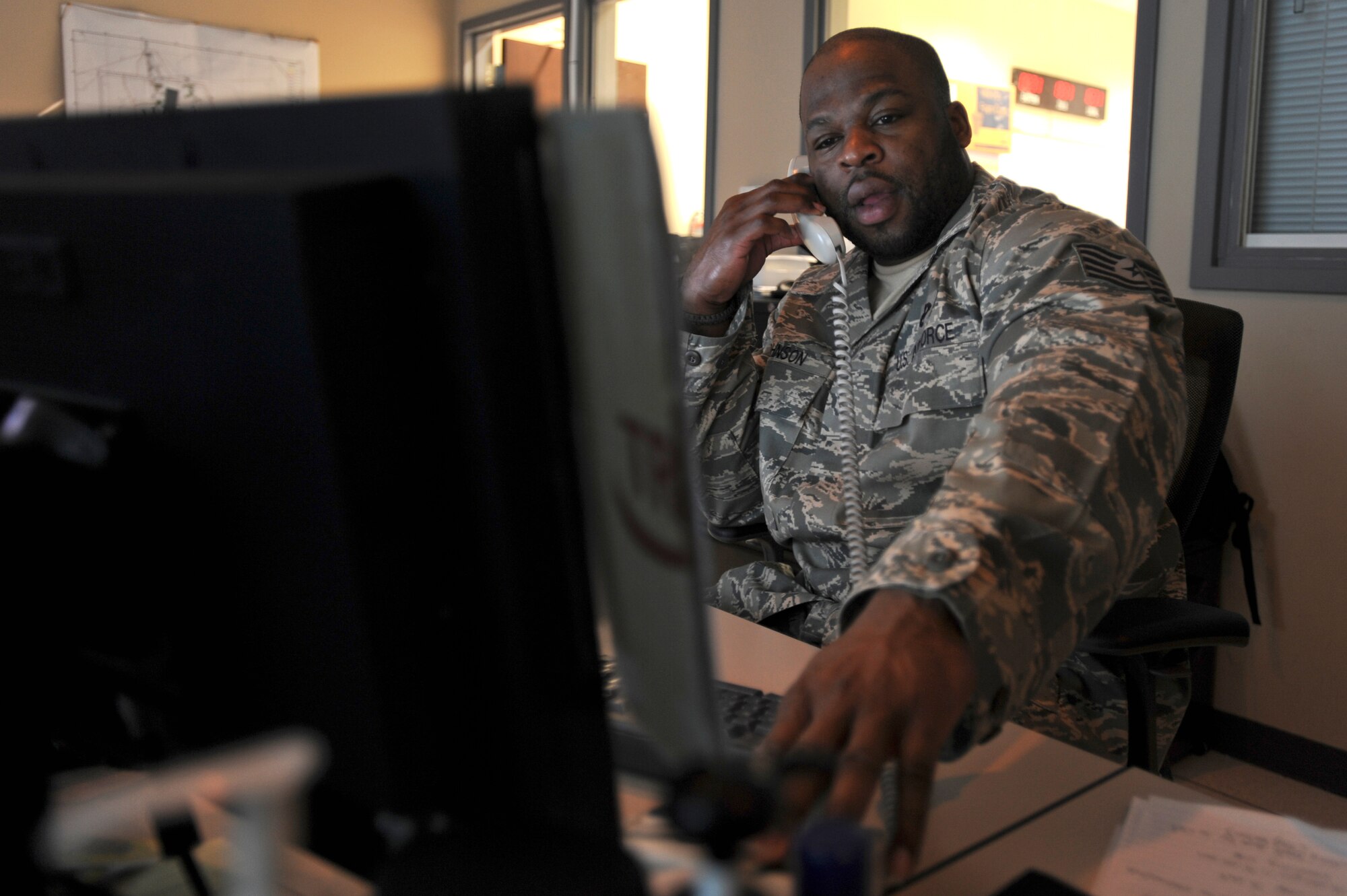 Tech. Sgt. Darrell Johnson, the Maintenance Operations Center Weapons System Senior Controller with the 379th Expeditionary Maintenance Operations Squadron, initiates an emergency action checklist for an in-flight emergency, Jan. 22, 2009, in an undisclosed location in Southwest Asia. The checklist notifies all group leadership and proper agencies of the status of the emergency. Sergeant Johnson is originally from Richmond, Va. and is deployed from Kadena Air Base, Japan in support of Operations Iraqi and Enduring Freedom and Joint Task Force-Horn of Africa.(U.S. Air Force Photo by Staff Sgt. Joshua Garcia/Released)


