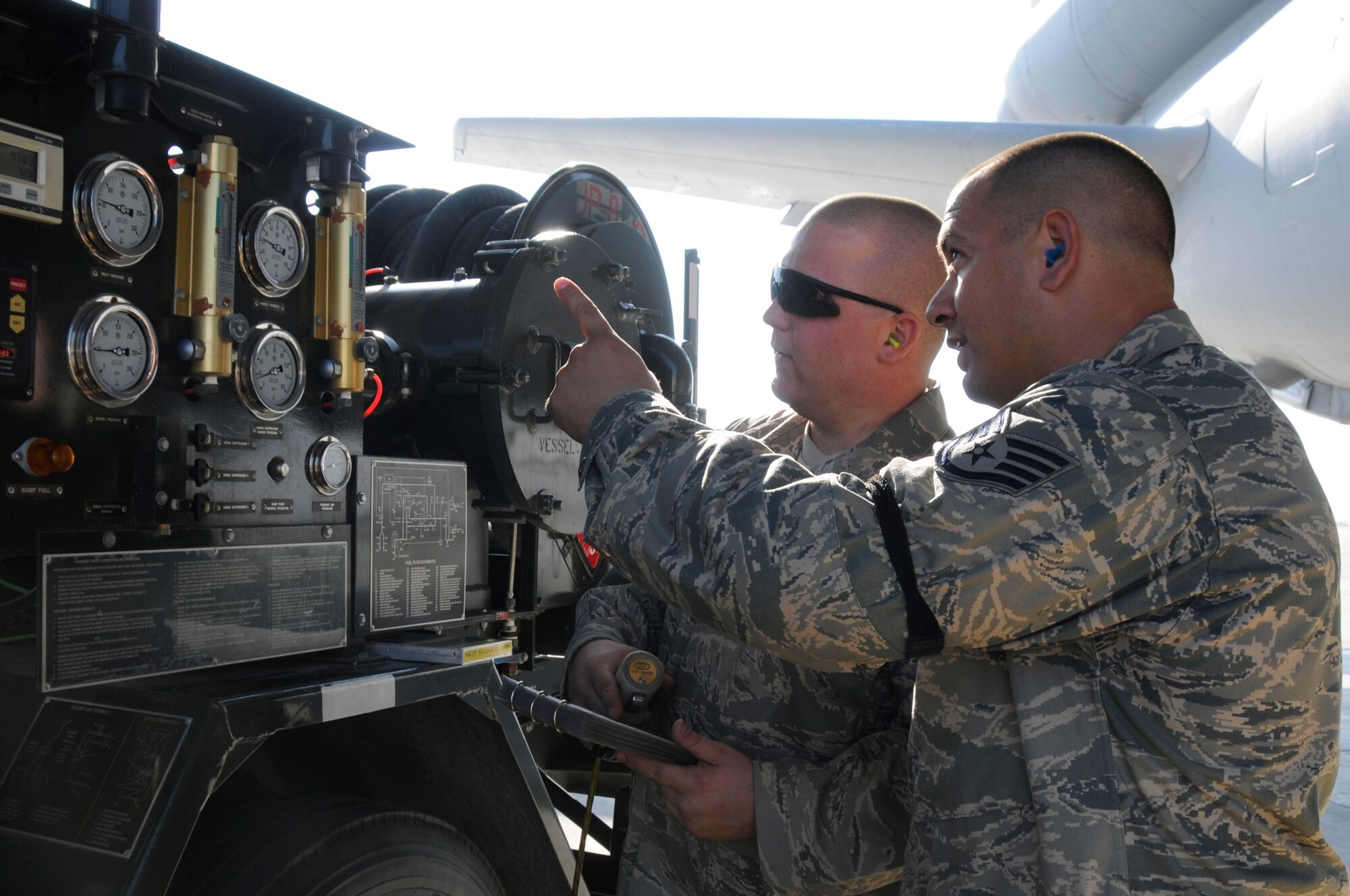 SOUTHWEST ASIA -- Staff Sgt. Joshua Schubert, 380th Expeditionary Logistics Readiness Squadron distribution supervisor performs a spot check on Airman 1st Class Brian Holley, 380th ELRS fuels operator as he refuels a KC-10 Extender, Jan 21. Sergeant Schubert performs checks at random to ensure proper procedures are followed during aircraft refueling. Sergeant Schubert is deployed from Eglin AFB, Fla. and is from Hatboro, Pa. Airman Holley is deployed from the 178th Fighter Wing, Ohio Air National Guard and is from Dayton, OH. (U.S. Air Force photo by Senior Airman Brian J. Ellis) (Released)