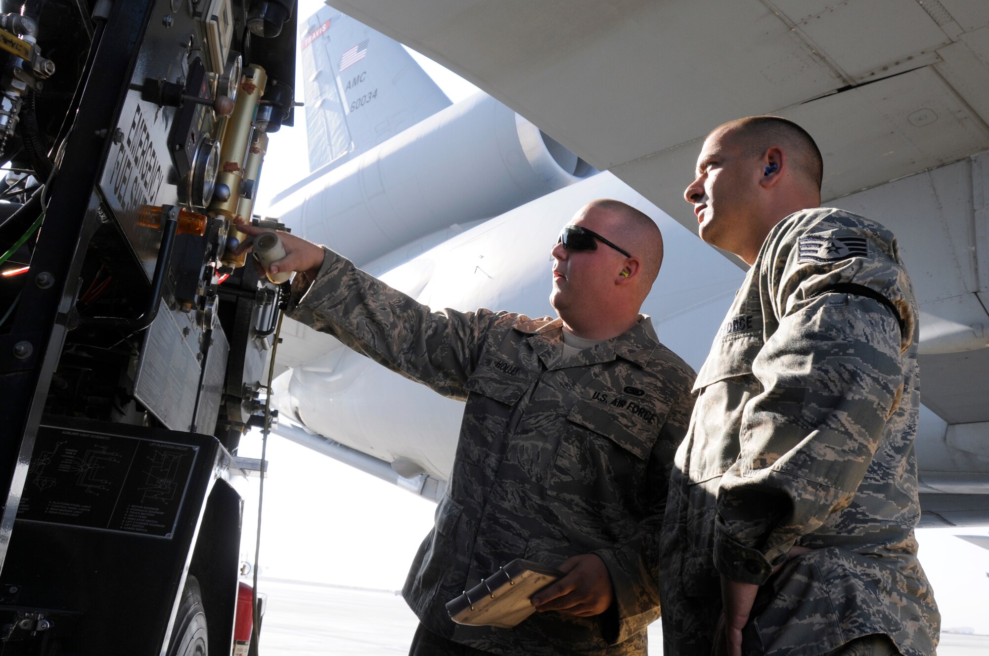 SOUTHWEST ASIA -- Airman 1st Class Brian Holley, 380th Expeditionary Logistics Readiness Squadron fuels operator goes through the procedures of refueling a KC-10 Extender with Staff Sgt. Joshua Schubert, 380th ELRS distribution supervisor, Jan 21. Sergeant Schubert performs checks at random to ensure proper procedures are followed and assists other Airmen when needed during aircraft refueling. Sergeant Schubert is deployed from Eglin AFB, Fla. and is from Hatboro, Pa. Airman Holley is deployed from the 178th Fighter Wing, Ohio Air National Guard and is from Dayton, OH. (U.S. Air Force photo by Senior Airman Brian J. Ellis) (Released)