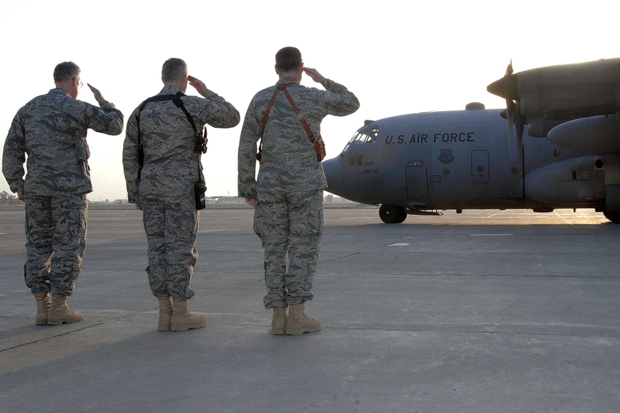 KIRKUK REGIONAL AIR BASE, Iraq – Col. John Costa, 506th Air Expeditionary Group commander, Lt. Col. Timothy McCoy, 506th AEG deputy commander, and Chief Master Sgt. Bill Goben, group superintendent, render a salute to Brig. Gen. Brian Bishop, 332nd Air Expeditionary Wing commander, as his departing aircraft taxies down the runway Jan. 21. Bishop toured several units during his trip to Kirkuk RAB visiting with the Airmen. (U.S. Air Force photo by Senior Airman Eunique Stevens)