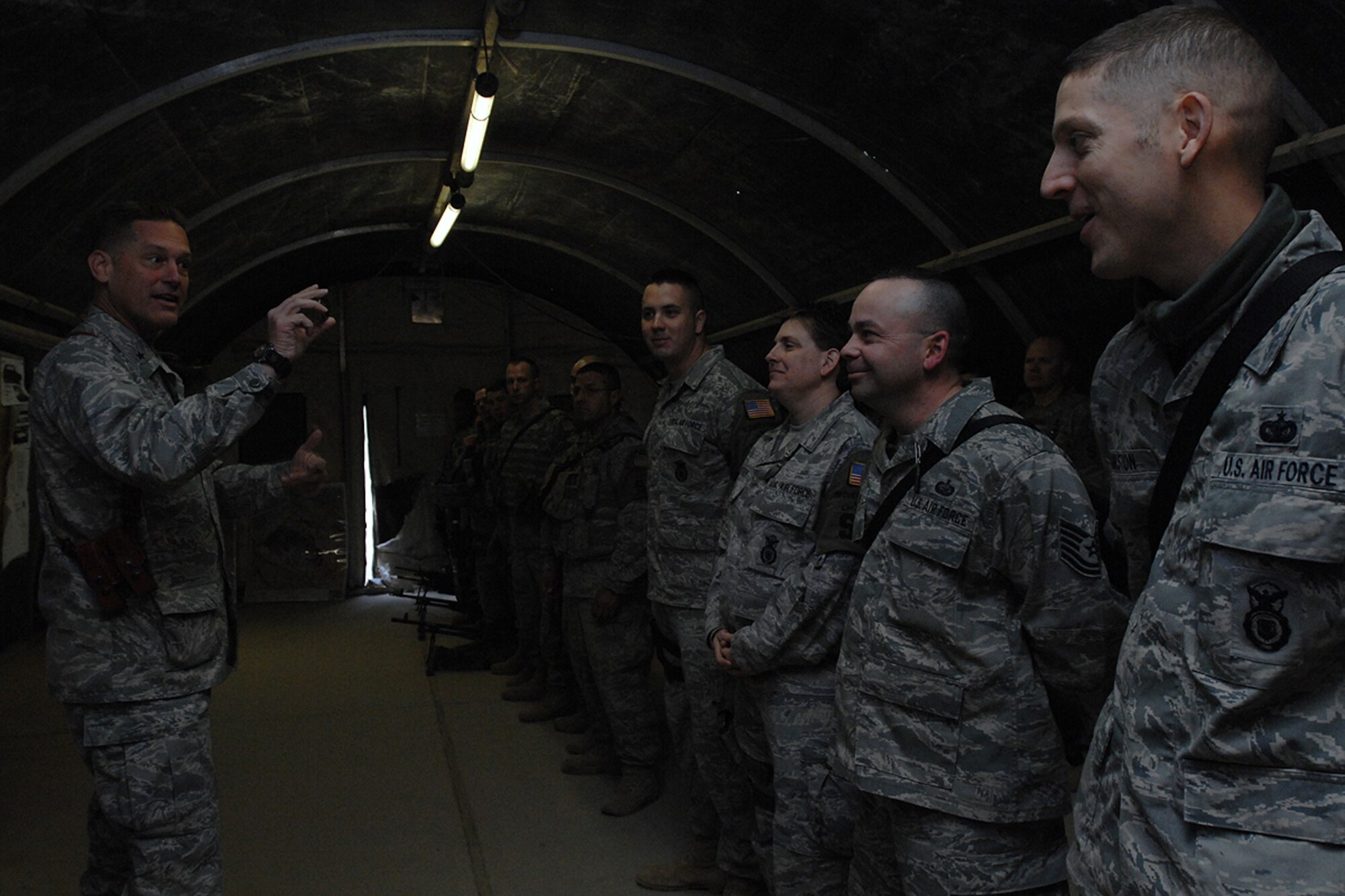 KIRKUK REGIONAL AIR BASE, Iraq – Brig. Gen. Brian Bishop, 332nd Air Expeditionary Wing commander, discusses the history of the wing challenge coin with members of the 506th Expeditionary Security Forces Squadron here Jan. 21. Bishop visited each of the 506th Air Expeditionary Group’s six squadrons during his one day trip to Kirkuk RAB. (U.S. Air Force photo by Senior Airman Eunique Stevens)