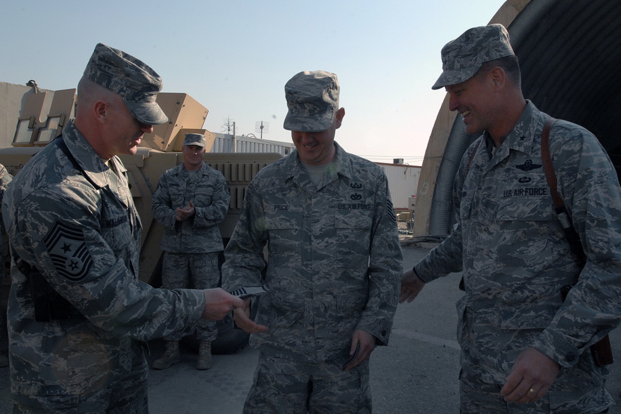 KIRKUK REGIONAL AIR BASE, Iraq – Brig. Gen. Brian Bishop, 332nd Air Expeditionary Wing commander, and Chief Master Sgt. David Williamson, 332nd AEW command chief, present Master Sgt. Charles Price, 506th Expeditionary Civil Engineer Squadron, with a new set of rank insignia here Jan. 21. Price was surprised to learn that he was selected for promotion via the Stripes for Exceptional Performers program. The Ft. Lauderdale, Fla., native is deployed here from RAF Lakenheath, England. (U.S. Air Force photo by Senior Airman Eunique Stevens)