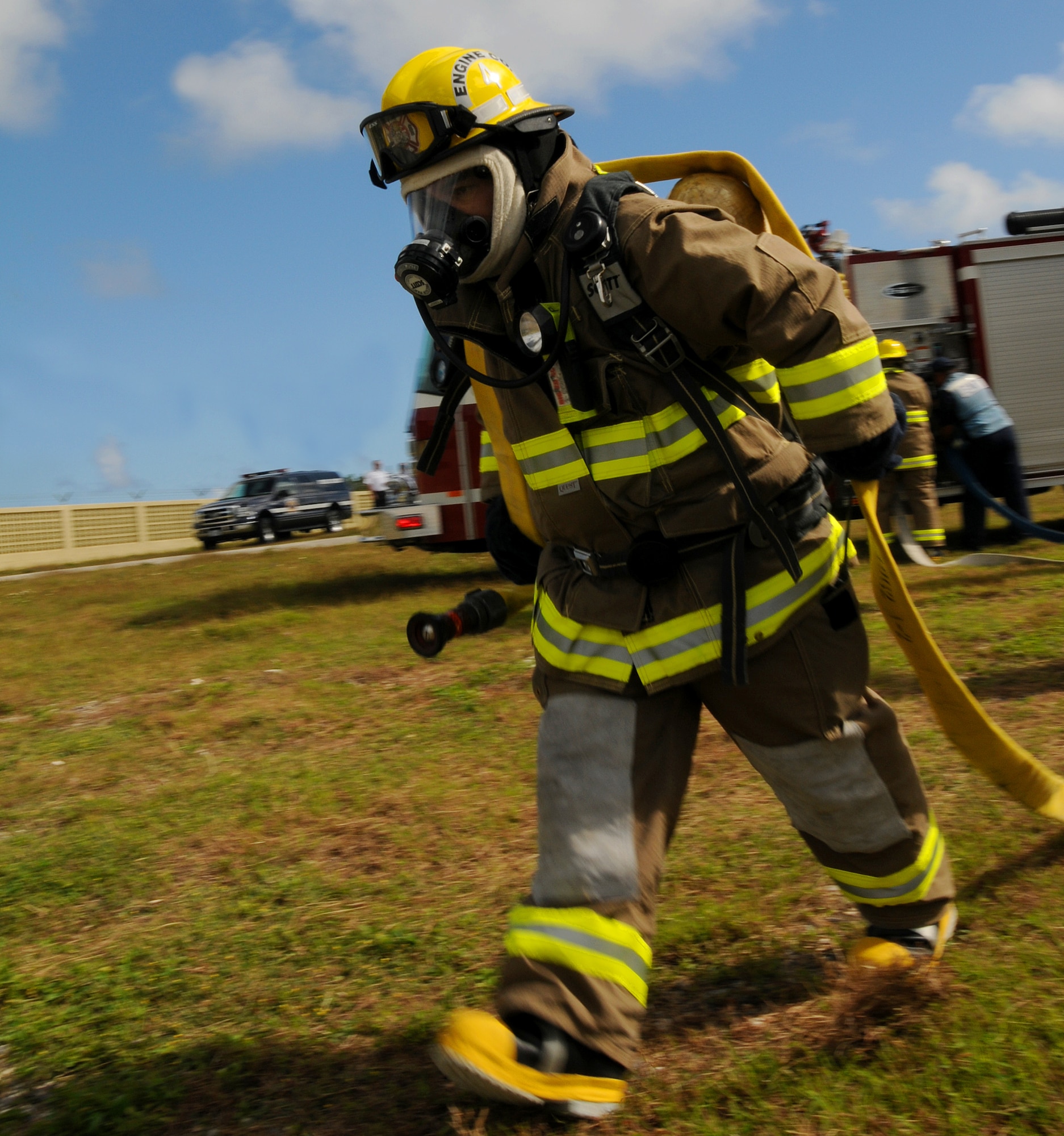 ANDERSEN AIR FORCE BASE, Guam - Pascual Uncangco, from the Yigo Fire Department, positions a hose for training here Jan. 22. Live-fire training allows firefighters the opportunity to challenge themselves through realistic scenarios designed to train everyone from the rookie to seasoned firefighters. (U.S. Air Force photo by Airman 1st Class Courtney Witt)