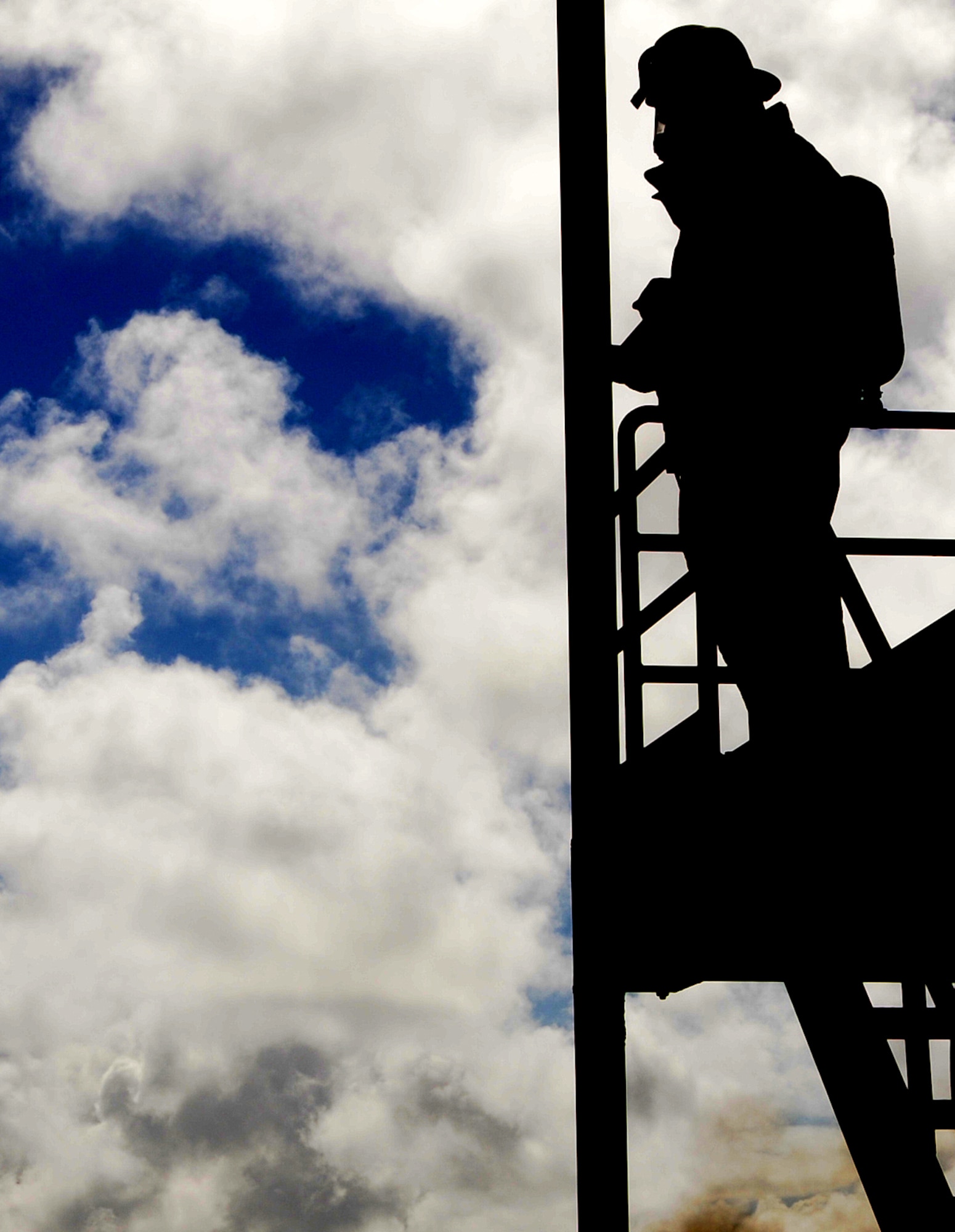 ANDERSEN AIR FORCE BASE, Guam - Fire Specialist J.T. Santos takes a break after fighting a fire on Andersen's structural tower during a joint training mission with DoD, GovGuam, and Won Pat International Airport fire departments here Jan. 22. (U.S. Air Force photo by Airman 1st Class Courtney Witt)