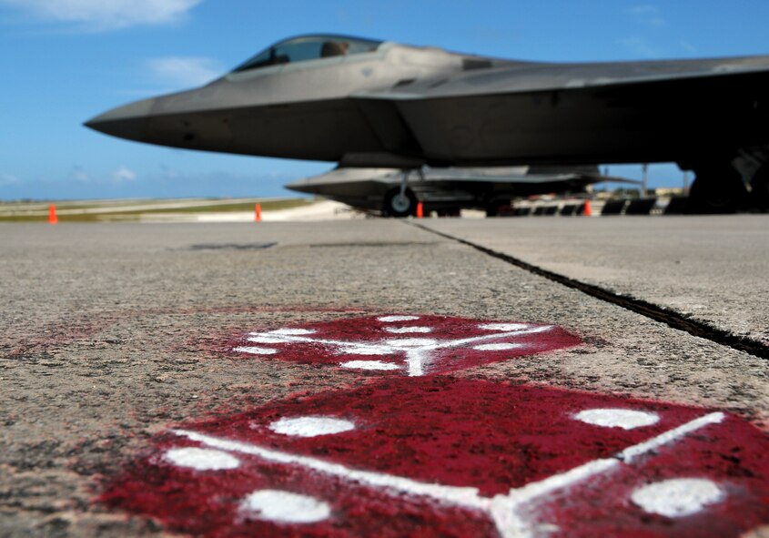 ANDERSEN AIR FORCE BASE, Guam - The 90th Expeditionary Fighter Squadron showcases an F-22 Raptor for media here Jan. 23. The F-22 is a highly maneuverable combat aircraft that can avoid enemy detection, cruise at supersonic speeds, and provide the joint force commander an unprecedented level of integrated situational awareness. The stealth-fighters, along with associated maintenance and support personnel, are deployed as 90th Expeditionary Fighter Squadron and will participate in exercises such as Cope Thaw and Jungle Shield that provide training in an environment different from their home station.  (U.S. Air Force photo by Airman 1st Class Courtney Witt)