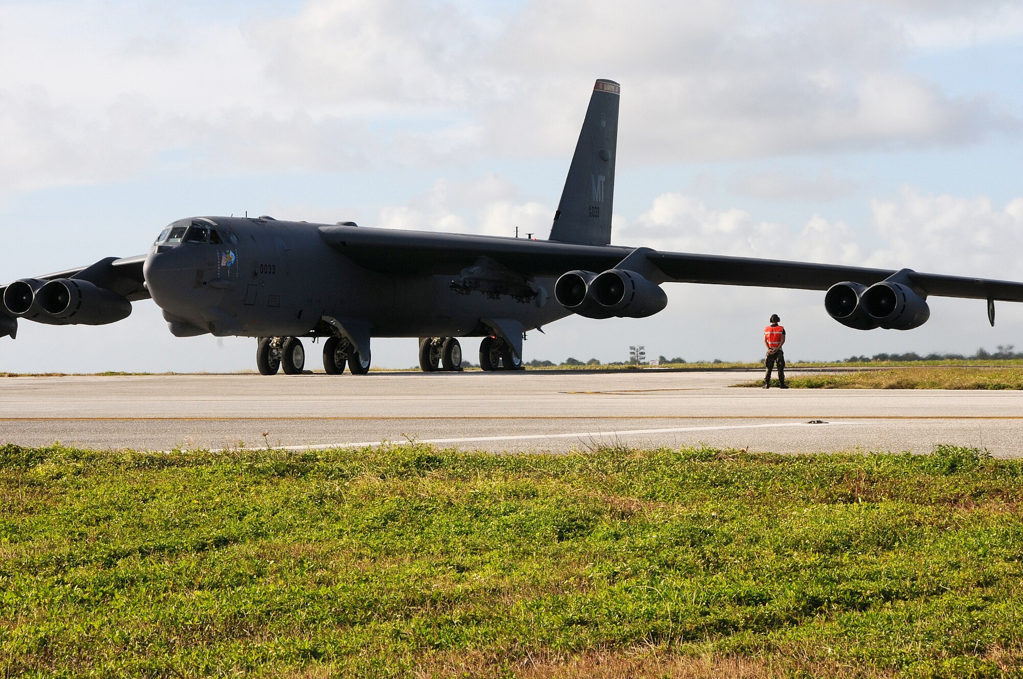 ANDERSEN AIR FORCE BASE, Guam - Airman 1st Class Octavio Villacreses Munioz 36th Expeditionary Maintenance Squadron maintainer, marshals a B-52 Stratofortress here Jan. 22. Aboard the aircraft Col. Gregory Cain 36th Wing Vice commander, takes his final flight. The Fini Flight was hosted by members of the 23d Expeditionary Bomb Squadron deployed from Minot Air Force Base, N.D.(U.S. Air Force photo by Senior Airman Nichelle Griffiths)