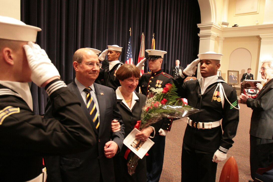 Secratary of the Navy Donald Winter escorts his wife through Navy and Marine "sideboys" during the conclusion of his farewell ceremony at Crawford Hall at Marine Barracks Washington, Jan. 23. Winter served three years as the SecNav.