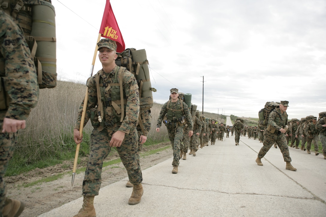 Marines with the 11th Marine Expeditionary Unit command element conduct an 11-mile conditioning hike here Jan. 22. The hike was the fourth and longest the command element has completed in a recent series of hikes.