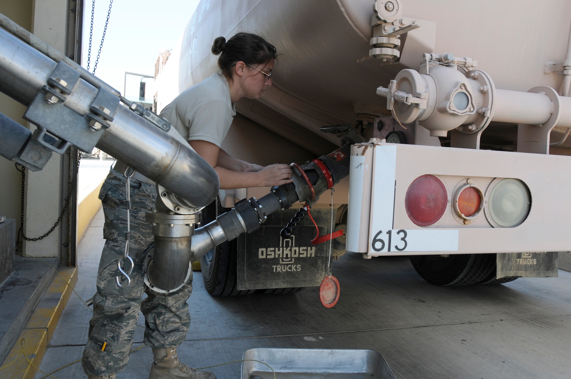 SOUTHWEST ASIA -- Senior Airman Jaclyn Laws, 380th Expeditionary Logistics Readiness Squadron fuels distribution operator hooks up an R-11 fuel truck to a fillstand, Jan 21. The fillstand gets fuel from the storage facility to replenish each fuel truck. On average the 380th ELRS fuels flight pumps 520,000 gallons a day into aricraft throughout Southwest Asia. Airman Laws is deployed from Eglin AFB, Fla. (U.S. Air Force photo by Senior Airman Brian J. Ellis) (Released)
