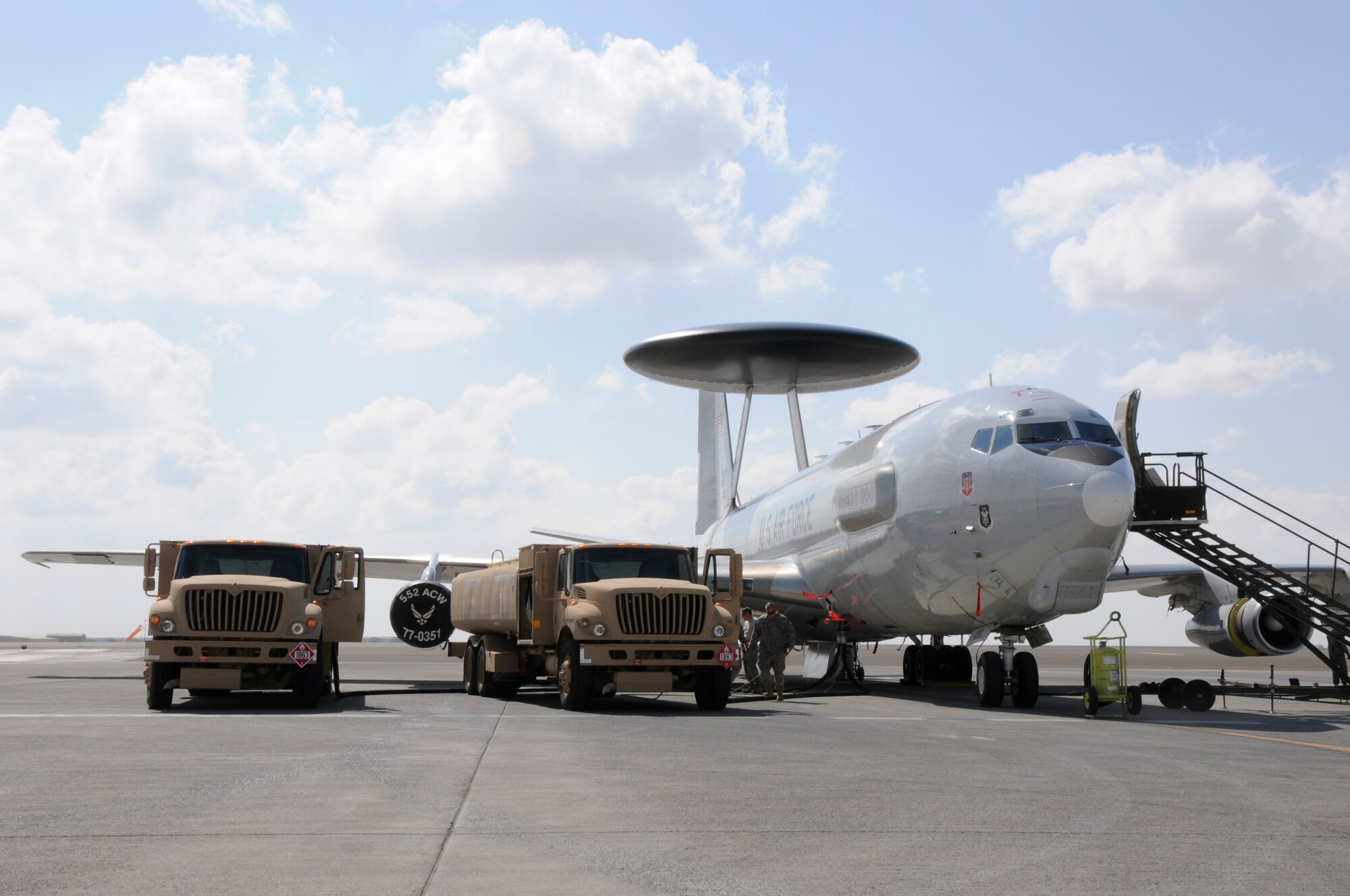 SOUTHWEST ASIA -- Two R-11 fuel trucks refuel an E-3 Sentry at the 380th Air Expeditionary Wing, Jan 21. The R-11 holds 6,000 gallons of fuel and is used to refuel the different aircraft at the 380th AEW. The E-3 Sentry takes 20,000 gallons to refuel when completely empty. The 380th is the second largest refueling wing in the Air Force distributing an average of 520,000 gallons a day to aircraft throughout southwest Asia. (U.S. Air Force photo by Senior Airman Brian J. Ellis) (Released)