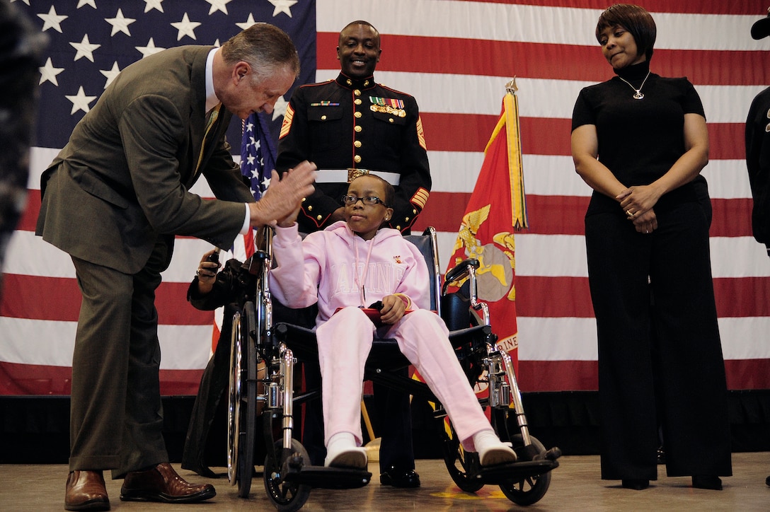 Briana Menendez gives a high five to the Mayor of Fort Worth, Mayor Michael J. Moncrief, moments after she is made an Honorary Marine during a ceremony at Naval Air Station Joint Reserve Base here Jan. 25.