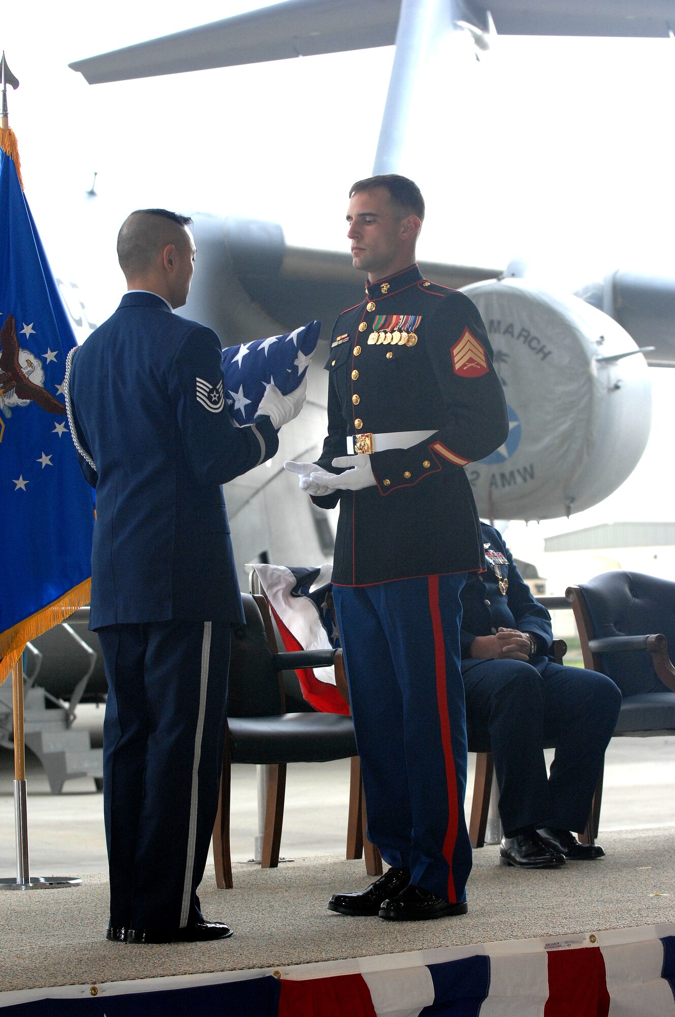 March Field "Blue Eagles" Honor Guard, Technical Sergeant Neil Ballacer, hands over a flag to Marine Sergeant Kyle Duignan.  A slight change in tradition, SGT. Duignan presented the flag to his father, Major General Robert E. Duignan, 4th AF Commander, during the general's retirement ceremony Jan 25, 2009 at March ARB, Calif.  General Duignan relinquished command of 4th Air Force to Brig. Gen. Eric Crabtree.  (U.S. Air Force photo/Technical Sgt. Joselito Aribuabo)(released)