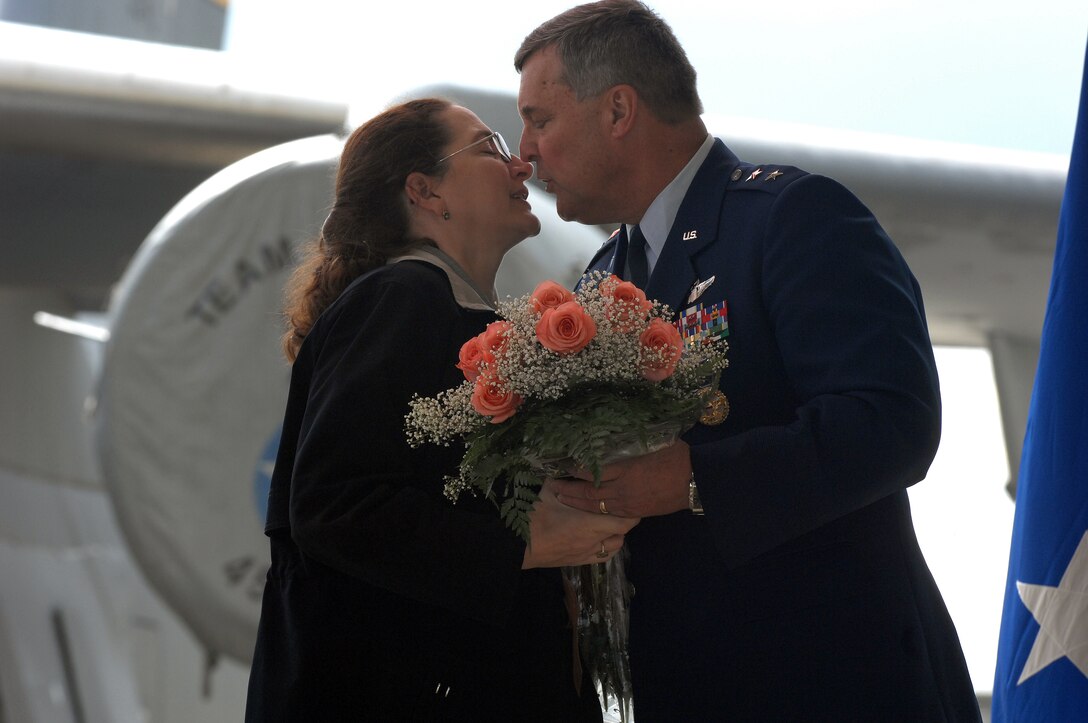 Major General Robert E. Duignan, Commander, Headquarters 4th Air Force, gives his wife, Ms. Karen Petruskevich, a kiss during his change of command and retirement ceremony, Jan. 25, 2009 at March ARB, Calif.   He passed command of the numbered Air Force to Brig. Gen. Eric Crabtree.  (U.S. Air Force photo/Technical Sgt. Joselito Aribuabo)(released)