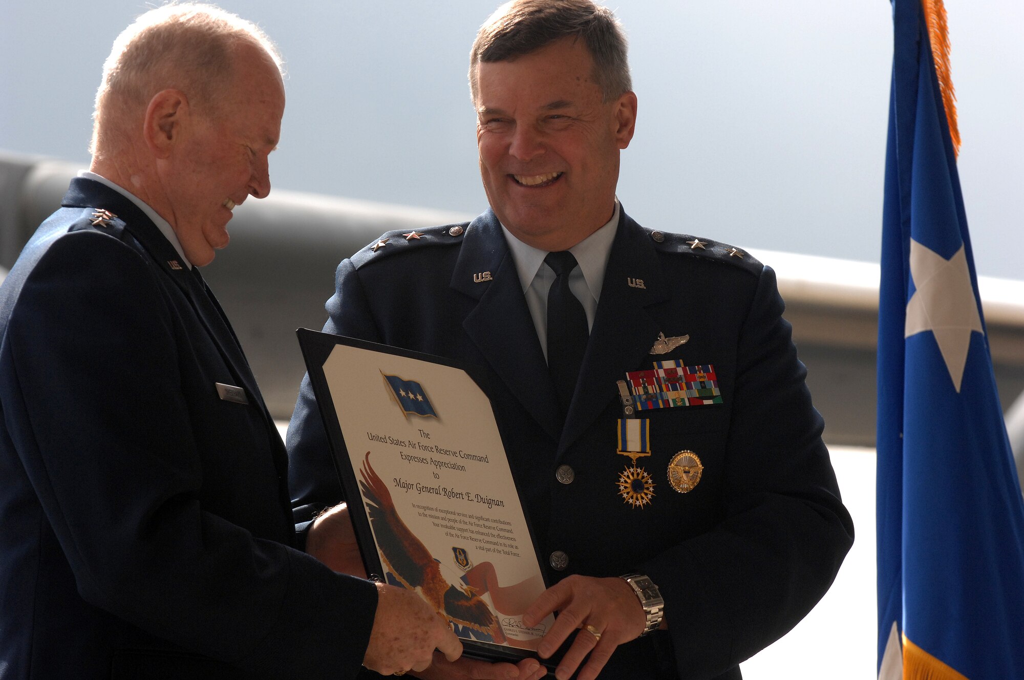 Lieutenant General James E. Sherrard III (ret.) presents Major General Robert E. Duignan some awards during General Duignan's change of command and retirement ceremony, Jan. 25, 2009, March ARB, Calif.  (U.S. Air Force photo/Technical Sgt.Joselito Aribuabo)(released)