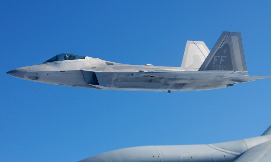 An F-22 Raptor flies along side a KC-135 Stratotanker during an air refueling mission over Kadena Air Base, Japan Jan. 23, 2009. The F-22 is deployed from 27th Fighter Wing Langley Air Force Base, Va. in support of U.S. Pacific Command. (U.S. Air Force photo/Airman 1st Class Chad Warren)
