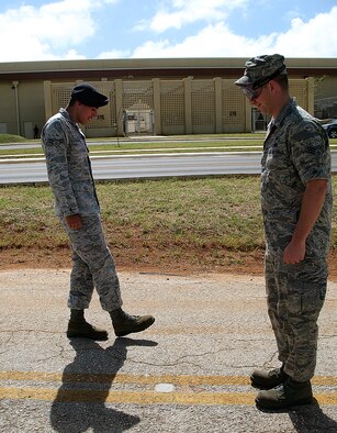 ANDERSEN AIR FORCE BASE, Guam - Airman 1st Class Sean Jarvis, 36th Security Forces Squadron, conducts a mock field sobriety test at the driving while under the influence demonstration at Arc Light Memorial Park Jan. 23 here. Senior Airman Matthew Laughlin, 36th Operations Support Squadron, wore impaired vision simulators calibrated to simulate a .17 to 1.2 blood alcohol content during the mock field sobriety test. The demonstration was part of the Wingman Day celebration across the base with the theme of "I got your back." (U.S. Air Force photo by Airman 1st Class Carissa Wolff)