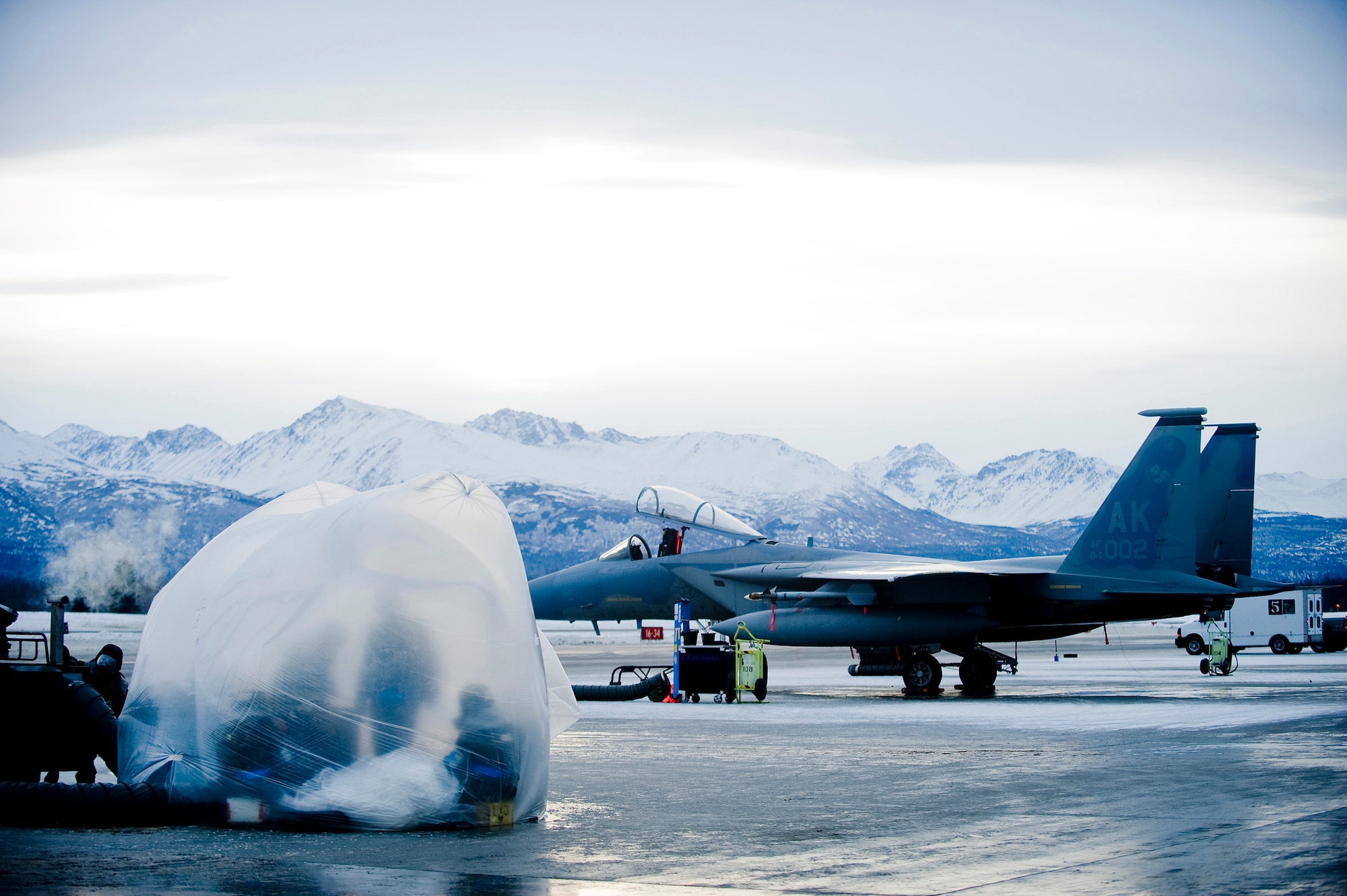 ELMENDORF AIR FORCE BASE, Alaska-- F-15 crew chiefs from the 19th Aircraft Maintenance Unit (AMU) wait in their heat bubble for the F-15s to land Jan. 22. The 19th AMU participated in Polar Force Exercise 09-2 in preparation for an upcoming Operation Readiness Inspection. (U.S. Air Force photo/Senior Airman Jonathan Steffen)