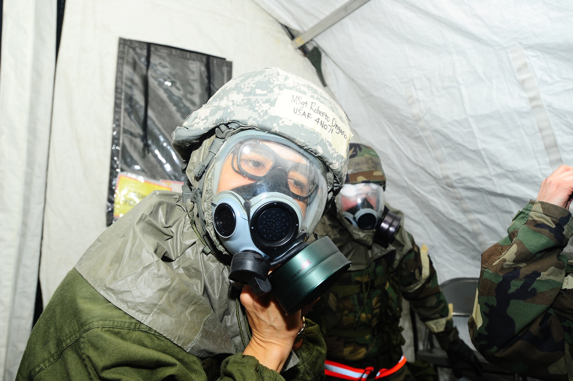 ELMENDORF AIR FORCE BASE, Alaska-- Master Sgt. Roberto Ongaro, 3rd Medical Surgical Squadron, dons his Mission Oriented Protective Posture level 4 gear, Jan. 21. MSgt Ongaro participated in Polar Force Exercise 09-2 in preparation for an upcoming Operation Readiness Inspection. (U.S. Air Force photo/Airman First Class Kristin High)