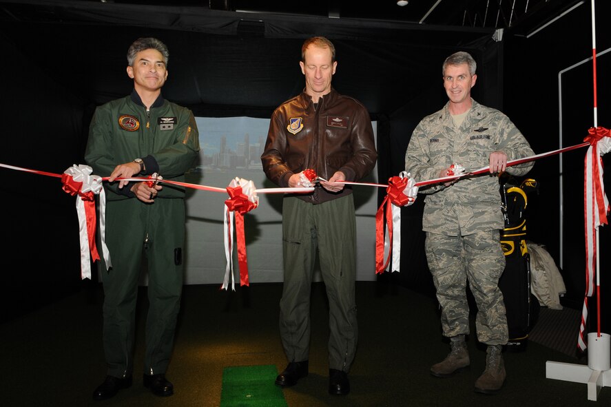 MISAWA AIR BASE, Japan -- Maj. Gen. Hiroaki Maehara, 3rd Air Wing commander, Col. David Stilwell, 35th Fighter Wing commander, and Col. Mark Burns, 35th Mission Support Group commander, take part in a ribbon-cutting ceremony Jan. 21, 2009, at the Gosser Memorial Golf Course. The ceremony marked the official opening of the Dead Solid Golf Simulator, which allows golfers to practice their skills during the winter season. (U.S. Air Force photo by Senior Airman Jamal D. Sutter)