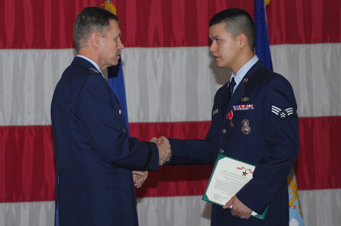 Airman 1st Class Antonio Antunez, a member of the 99th Security Forces Squadron, receives a Bronze Star with Valor from Gen. William M. Fraser III, Vice Chief of Staff of the Air Force, during an Airman's Call at Nellis Air Force Base, Nev. Jan. 26, 2009.  Airman Antunez was deployed to Iraq for six months is support of Operation Iraqi Freedom.  (U.S Air Force photo by Staff Sgt. Taylor Worley) 