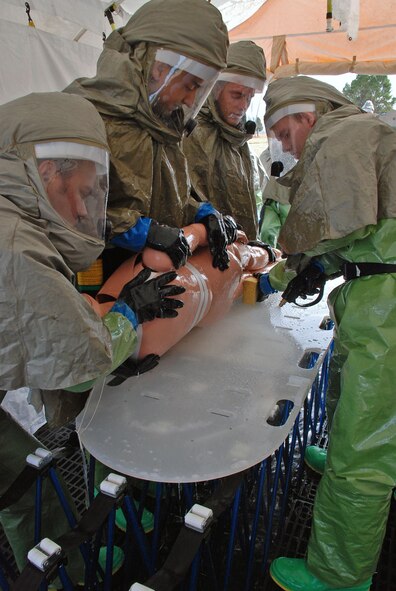 LAUGHLIN AIR FORCE BASE, Texas – Airmen from the 47th Medical Group work fast to decontaminate a simulated patient inside the In-Place-Patient-Decontamination-Capability tent here Jan. 15. The 24-person team learned to decontaminate more than 100 people in case of a chemical, biological or radiological incident during a two-day course Jan. 21 and 22. (U.S. Air Force photo by Airman 1st Class Sara Csurilla)