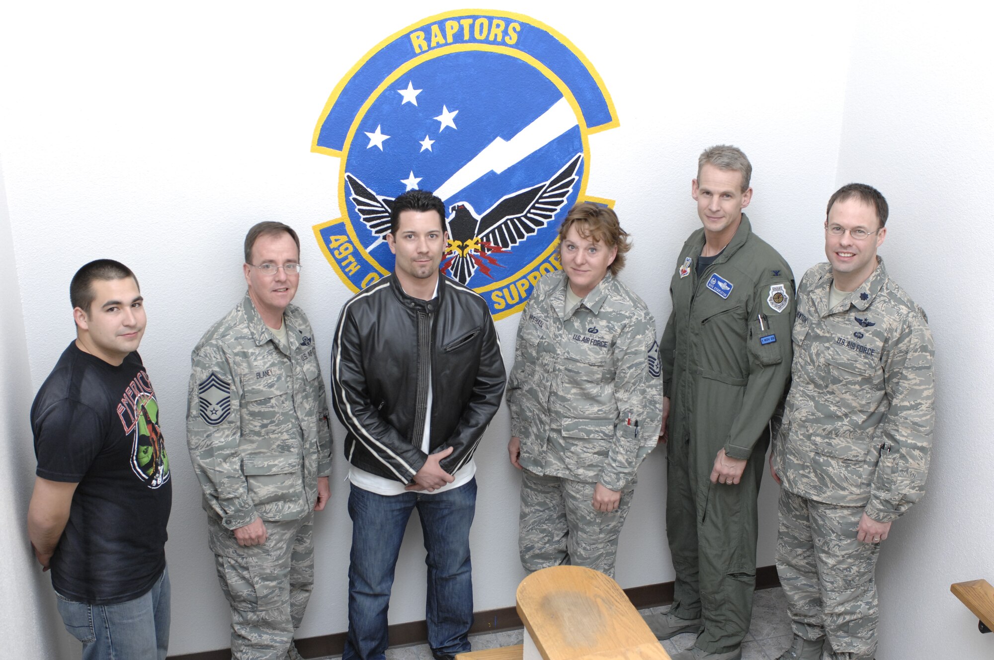 Senior Airman James Yonko, 49th Operations Support Squadron, poses for a group photo with other members at the 49 OSS after his return to Holloman Air Force Base, N.M., Jan. 22. Airman Yonko escorted local Iraqi nationals and worked with security forces during his 240-day deployment to Iraq. (U.S. Air Force photo/Airman 1st Class Rachel A. Kocin)