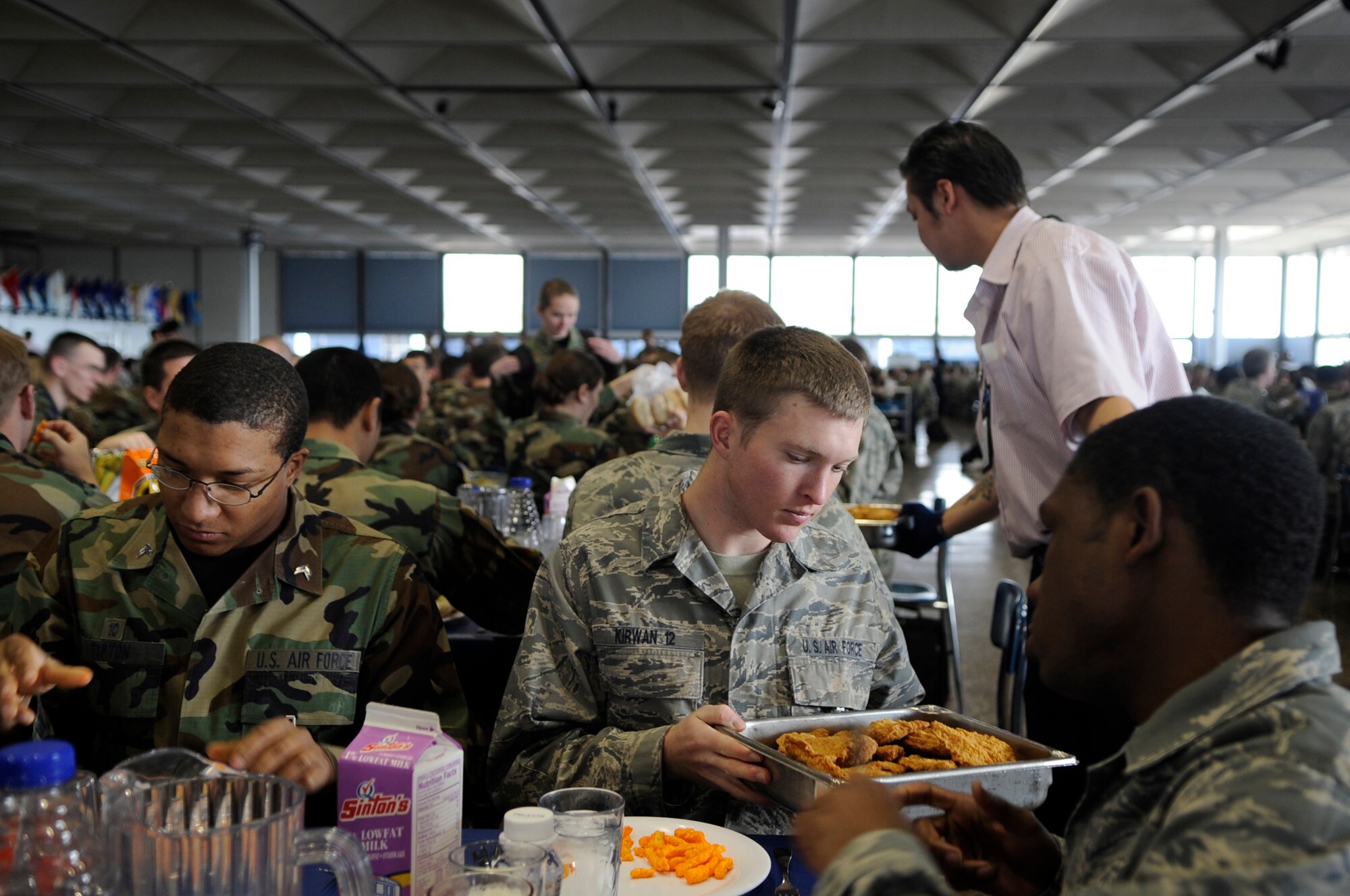 Cadets pass around fried chicken during lunch Jan. 23 at Mitchell Hall Cadet Dining Facility at the U.S. Air Force Academy in Colorado Springs, Colo. The dining facility feeds approximately 4450 cadets and sits on 1.75 acres. (U.S Air Force photo/Staff Sgt. Desiree N. Palacios)