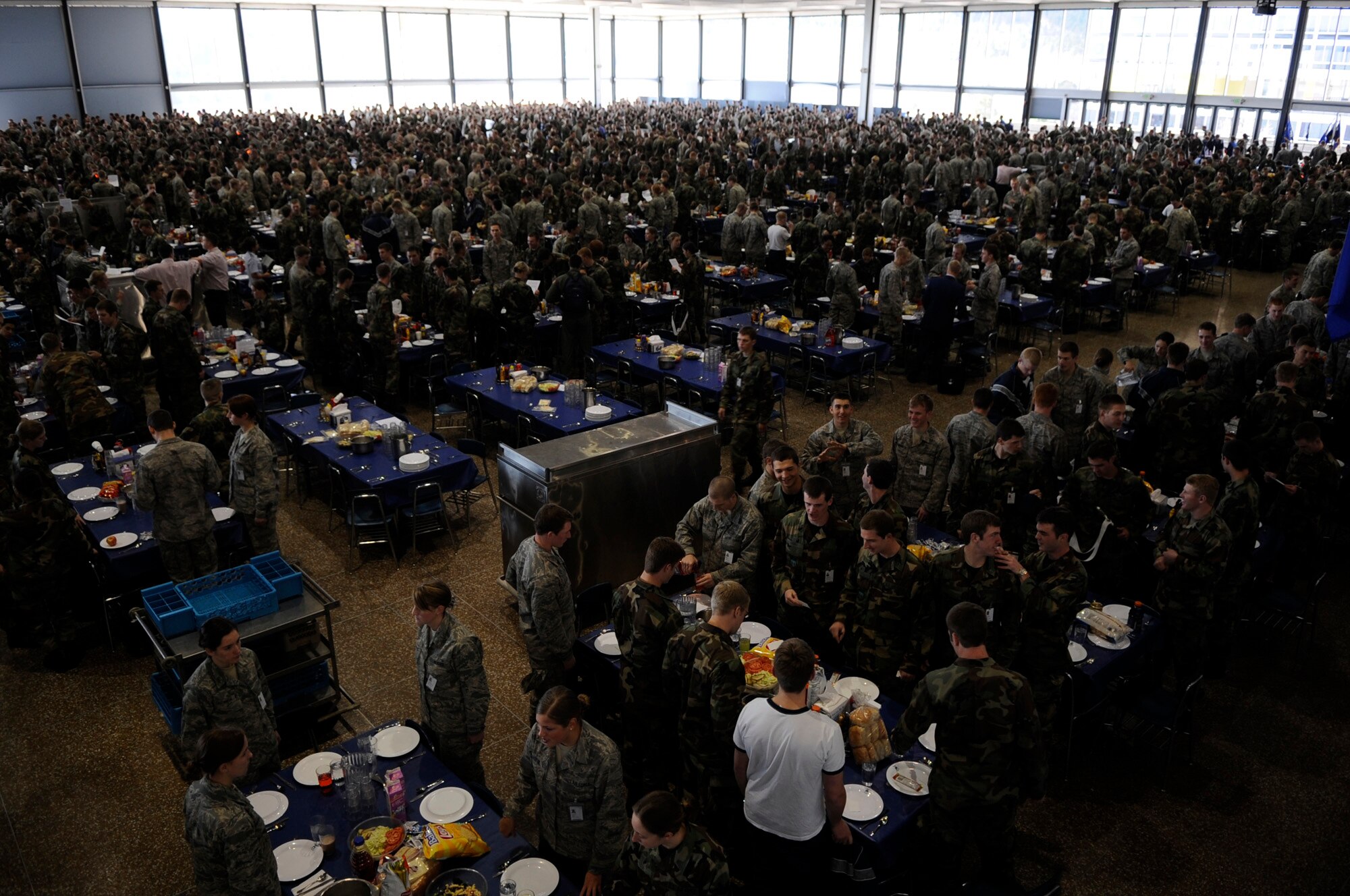 Cadets stand beside their chairs Jan. 23 as they wait for the rest of the cadets to enter Mitchell Hall Cadet Dining Facility at the U.S. Air Force Academy in Colorado Springs, Colo. so they can begin lunch. The dining facility feeds approximately 4450 cadets and sits on 1.75 acres. (U.S Air Force photo/Staff Sgt. Desiree N. Palacios)