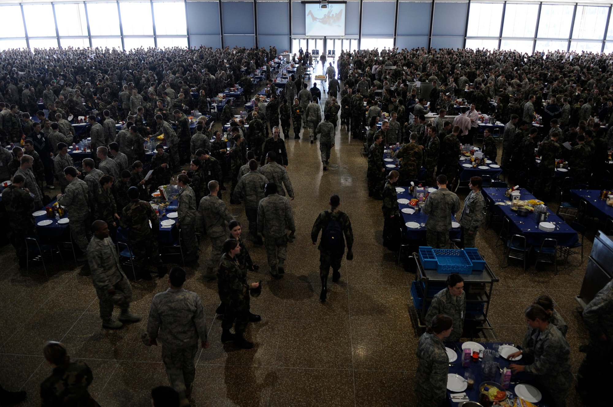 Cadets stand beside their chairs Jan. 23 as they wait for the rest of the cadets to enter Mitchell Hall Cadet Dining Facility at the U.S. Air Force Academy in Colorado Springs, Colo. so they can begin lunch. The dining facility feeds approximately 4450 cadets and sits on 1.75 acres. (U.S Air Force photo/Staff Sgt. Desiree N. Palacios)